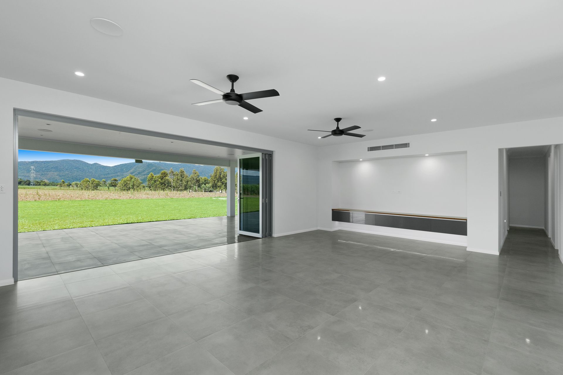 A Modern, Minimalist Living Room With Gray Tiled Floors — Ashlee Jones Homes in Gordonvale, QLD