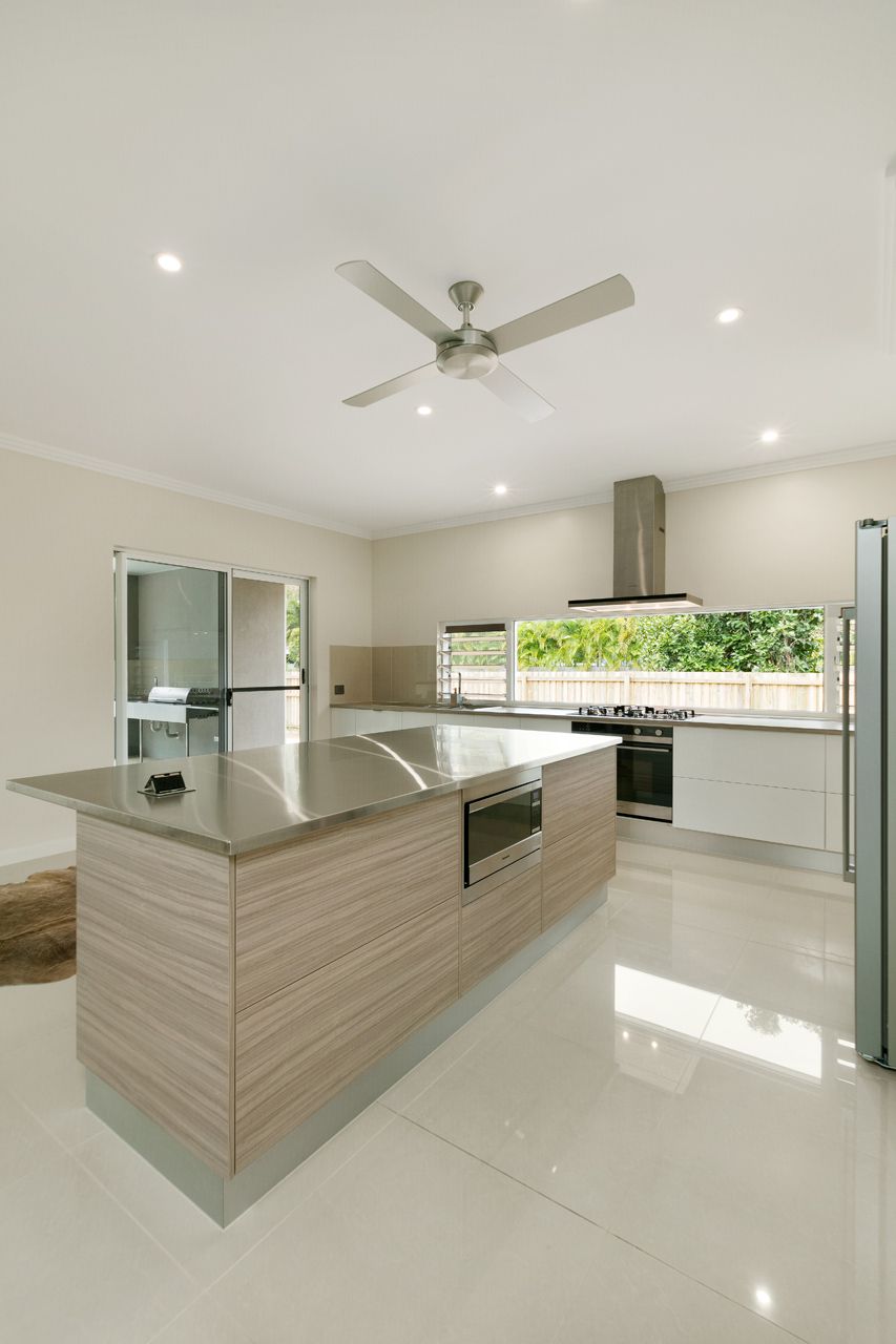 Modern Kitchen With a Light-wood Island, White Tile Floor — Ashlee Jones Homes in Gordonvale, QLD