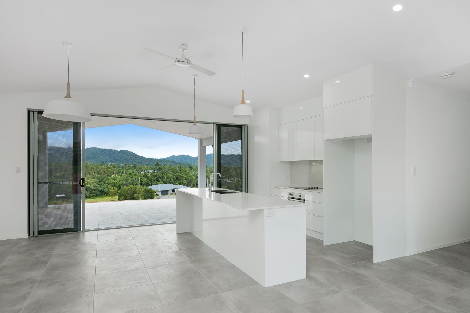 A Modern, All-white Kitchen With a Breakfast Island — Ashlee Jones Homes in Gordonvale, QLD
