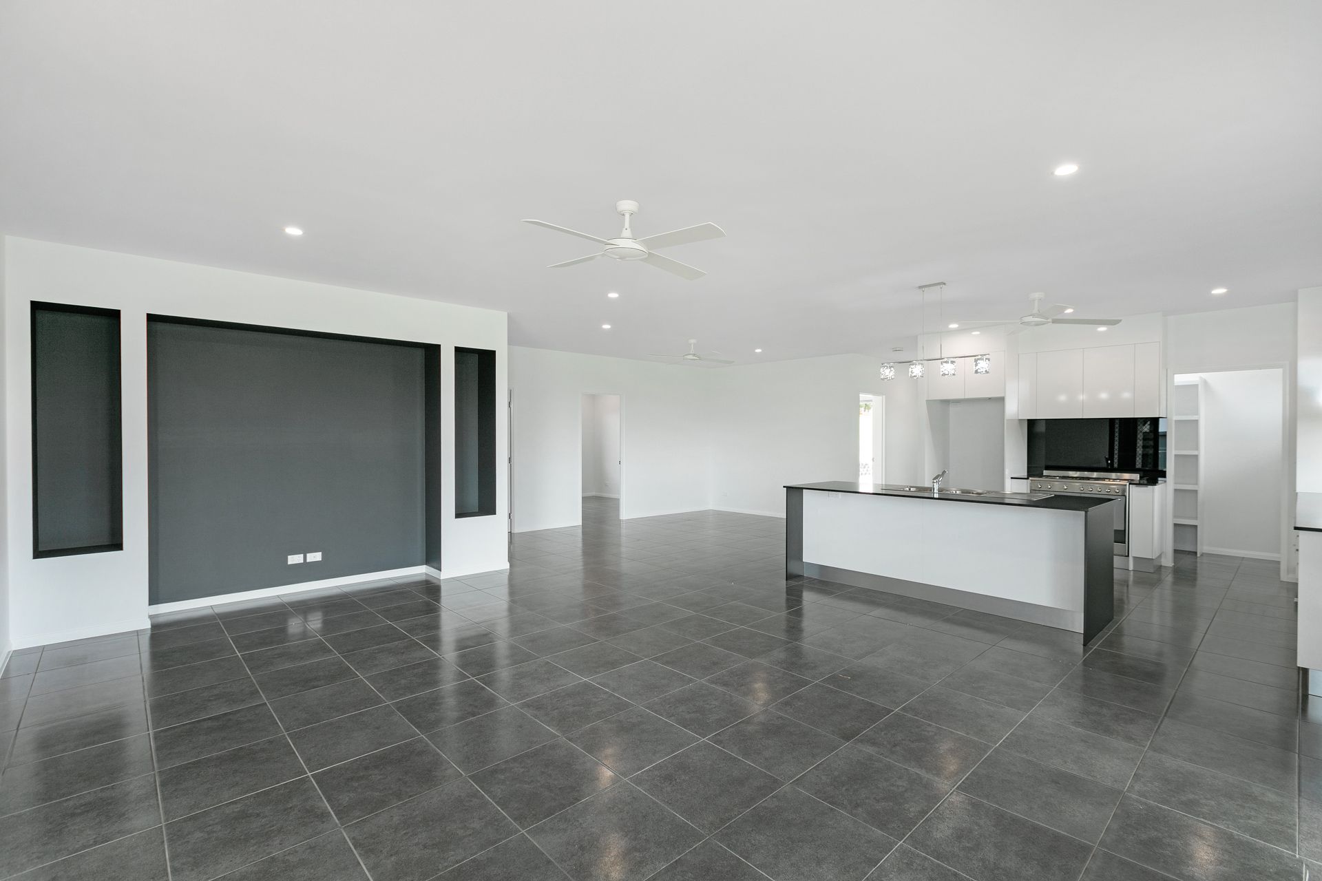 A Spacious, Modern Open-plan Room With Grey Tile Floors — Ashlee Jones Homes in Gordonvale, QLD