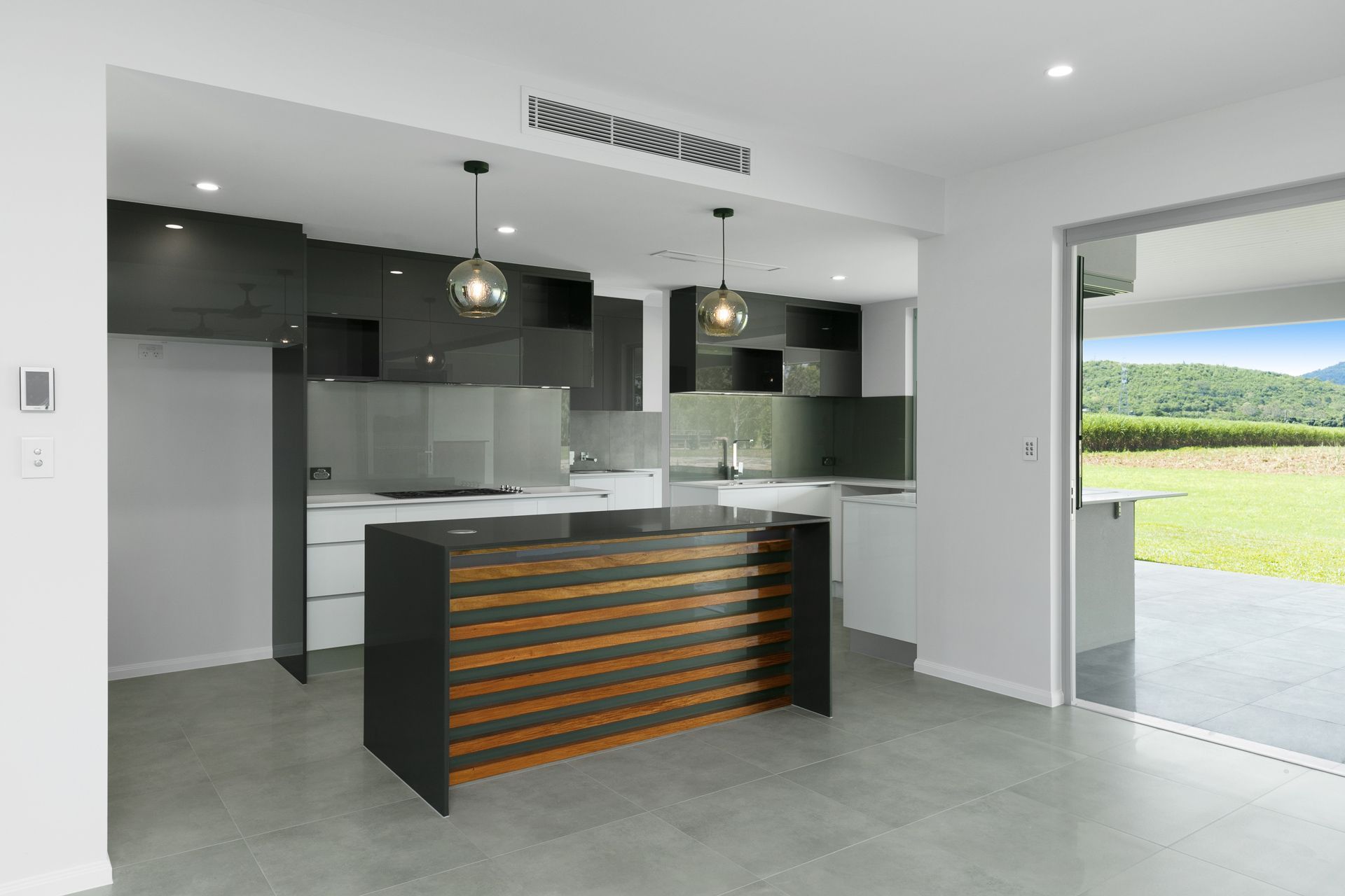 Modern Kitchen Featuring Dark Wood Cabinetry — Ashlee Jones Homes in Gordonvale, QLD