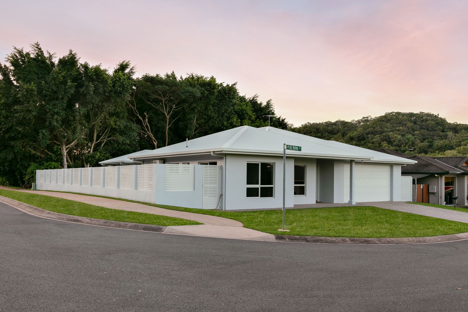 A Modern Single-story White House With a Garage and Privacy Fence — Ashlee Jones Homes in Gordonvale, QLD