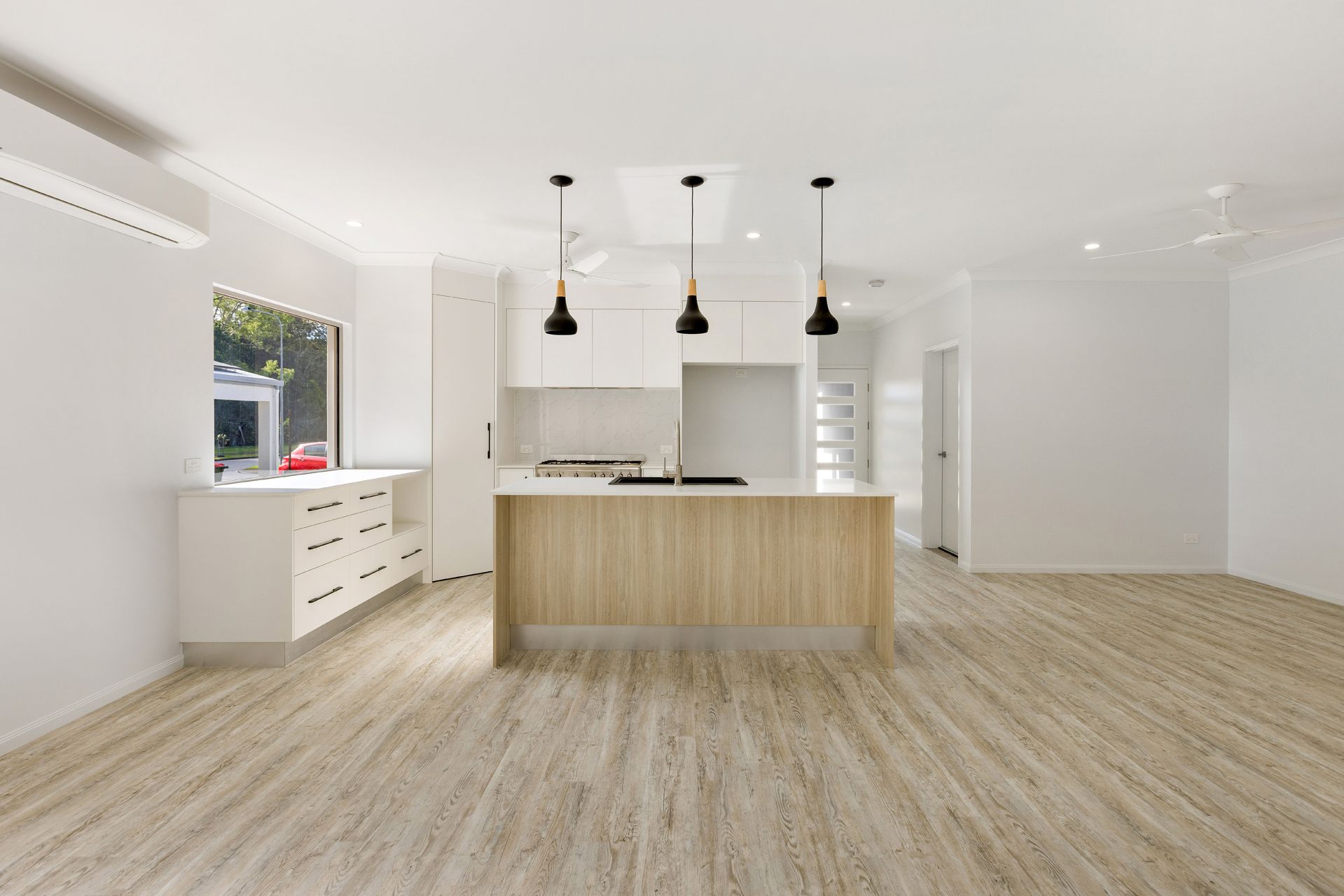 Modern Open-plan Kitchen With White Cabinetry — Ashlee Jones Homes in Gordonvale, QLD