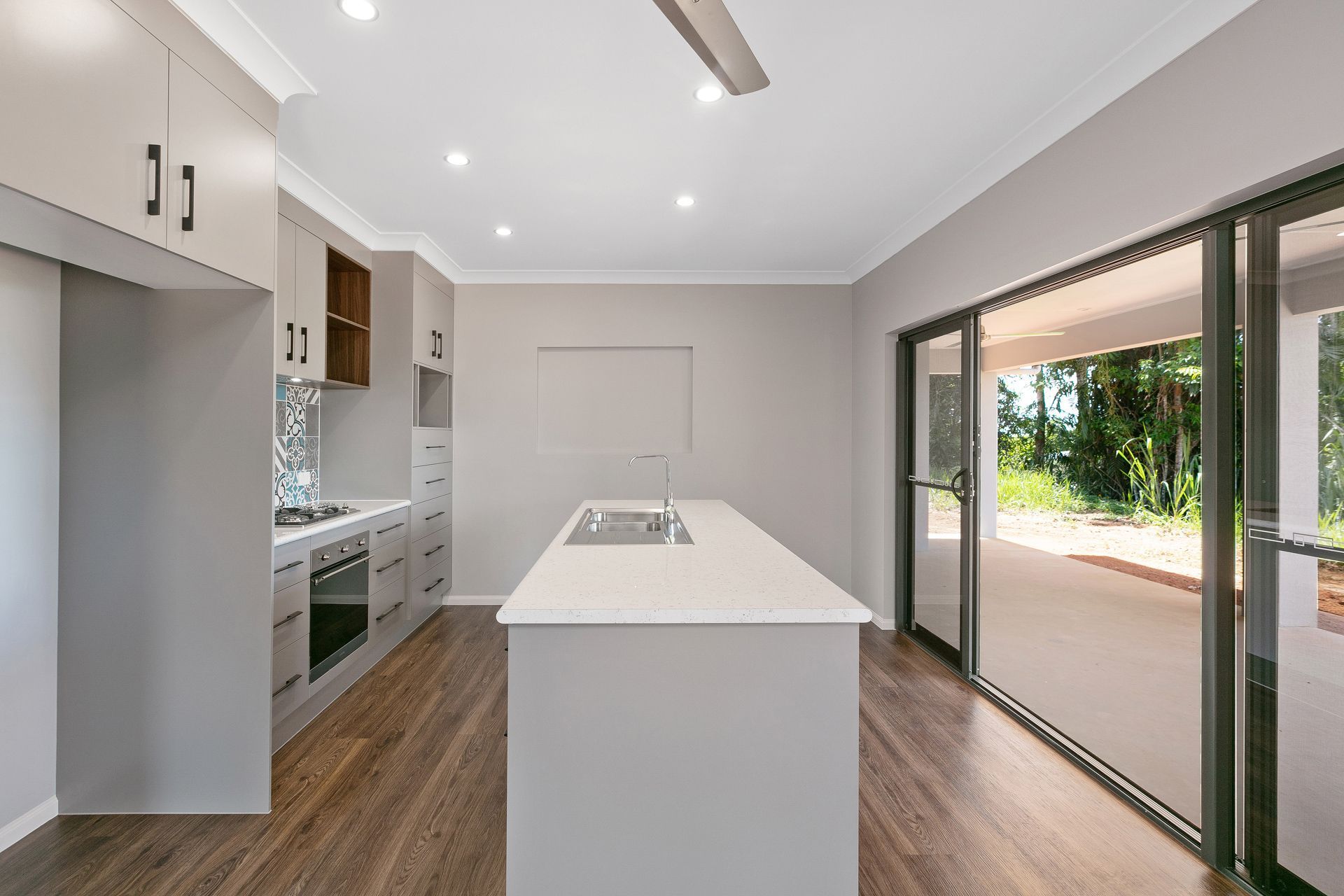 Modern Kitchen With a Central Island, Grey Cabinetry — Ashlee Jones Homes in Gordonvale, QLD