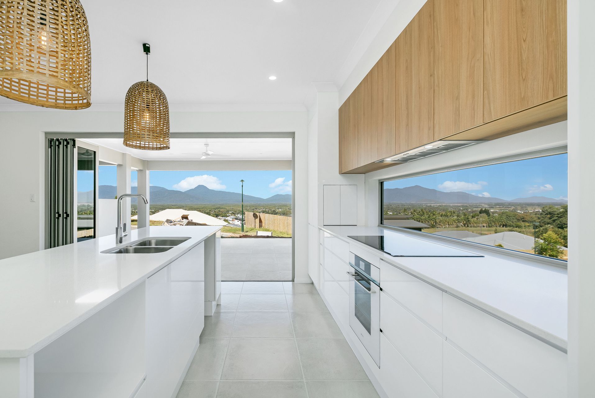 Modern Kitchen With White Countertops, Light Wood Cabinets — Ashlee Jones Homes in Gordonvale, QLD
