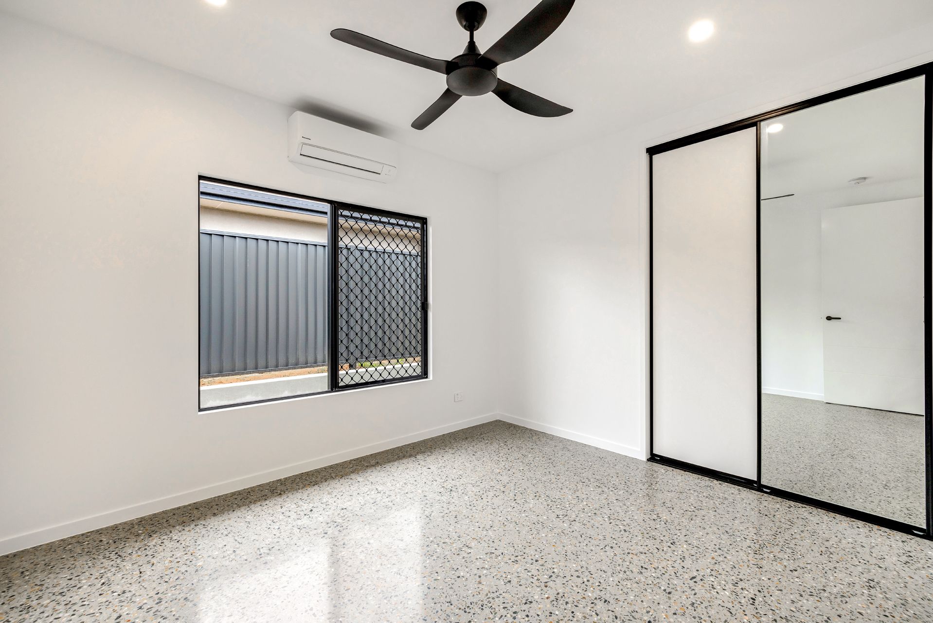 Empty Minimalist Bedroom With White Walls — Ashlee Jones Homes in Gordonvale, QLD