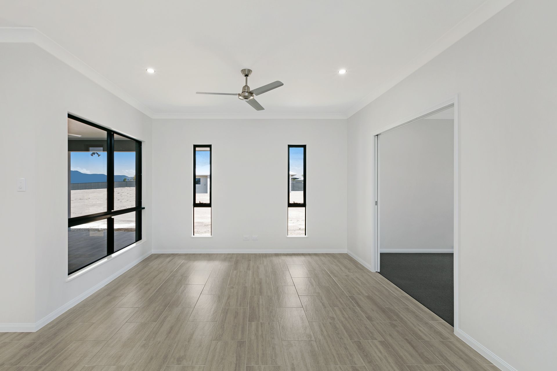 A Bright, Minimalist Room Featuring White Walls — Ashlee Jones Homes in Gordonvale, QLD