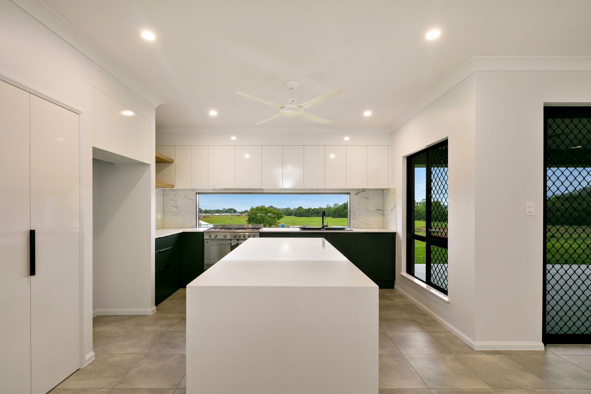 Modern Kitchen With White Island, Glossy White Overhead Cabinets — Ashlee Jones Homes in Gordonvale, QLD