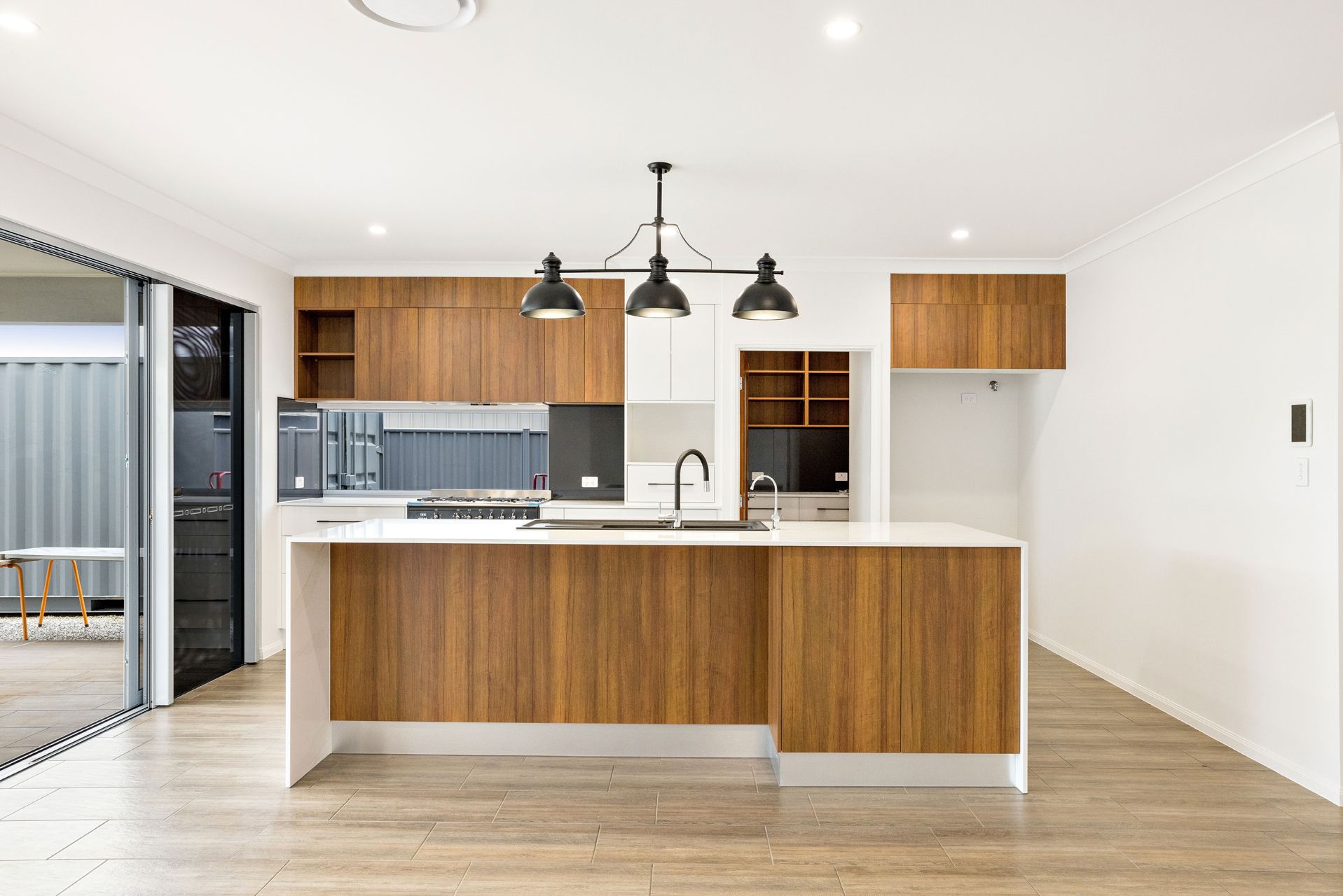 Modern Kitchen With Wooden Cabinetry — Ashlee Jones Homes in Gordonvale, QLD