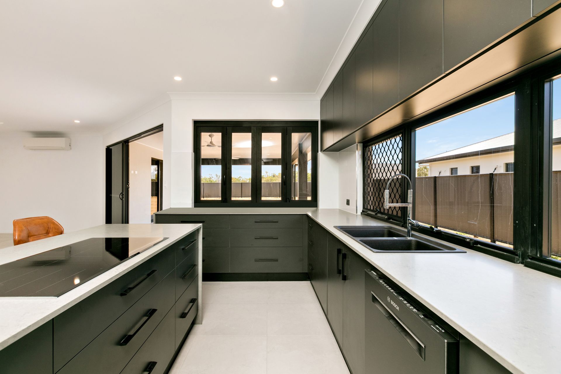 A Modern, Minimalist Kitchen With Matte Dark Grey Cabinets — Ashlee Jones Homes in Gordonvale, QLD