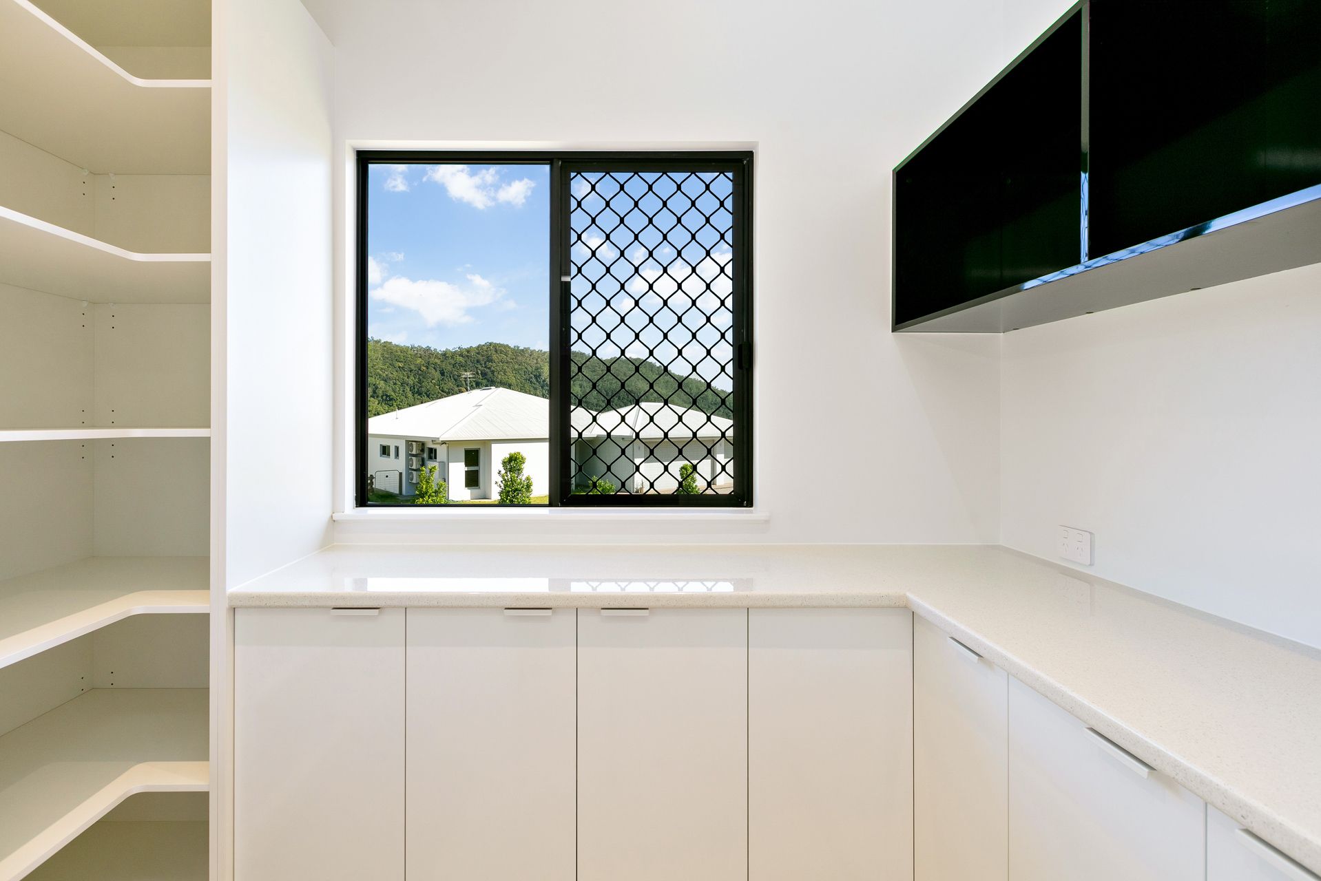A Bright, Modern Pantry With White Cabinetry — Ashlee Jones Homes in Gordonvale, QLD