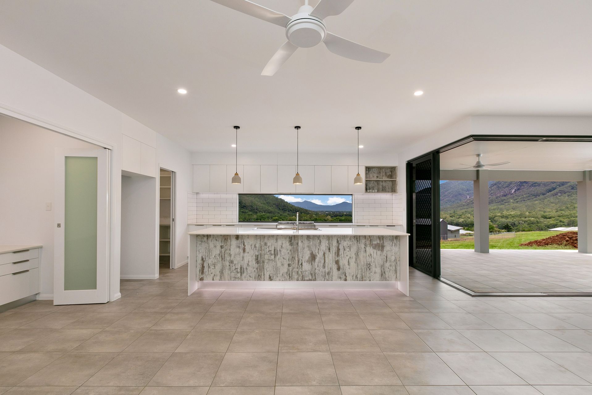 A Modern Open-plan Kitchen With a Marble-patterned Island — Ashlee Jones Homes in Gordonvale, QLD