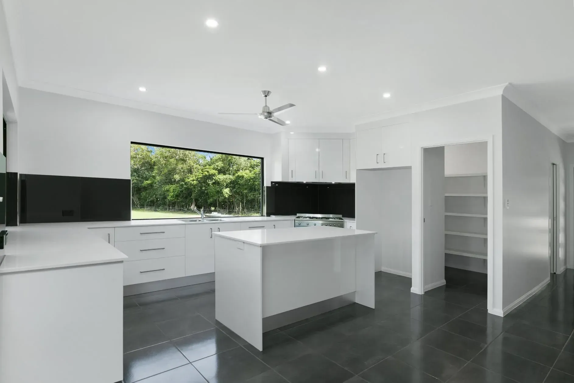 A Bathroom With Two Sinks, a Toilet, and a Walk in Shower — Ashlee Jones Homes in Gordonvale, QLD