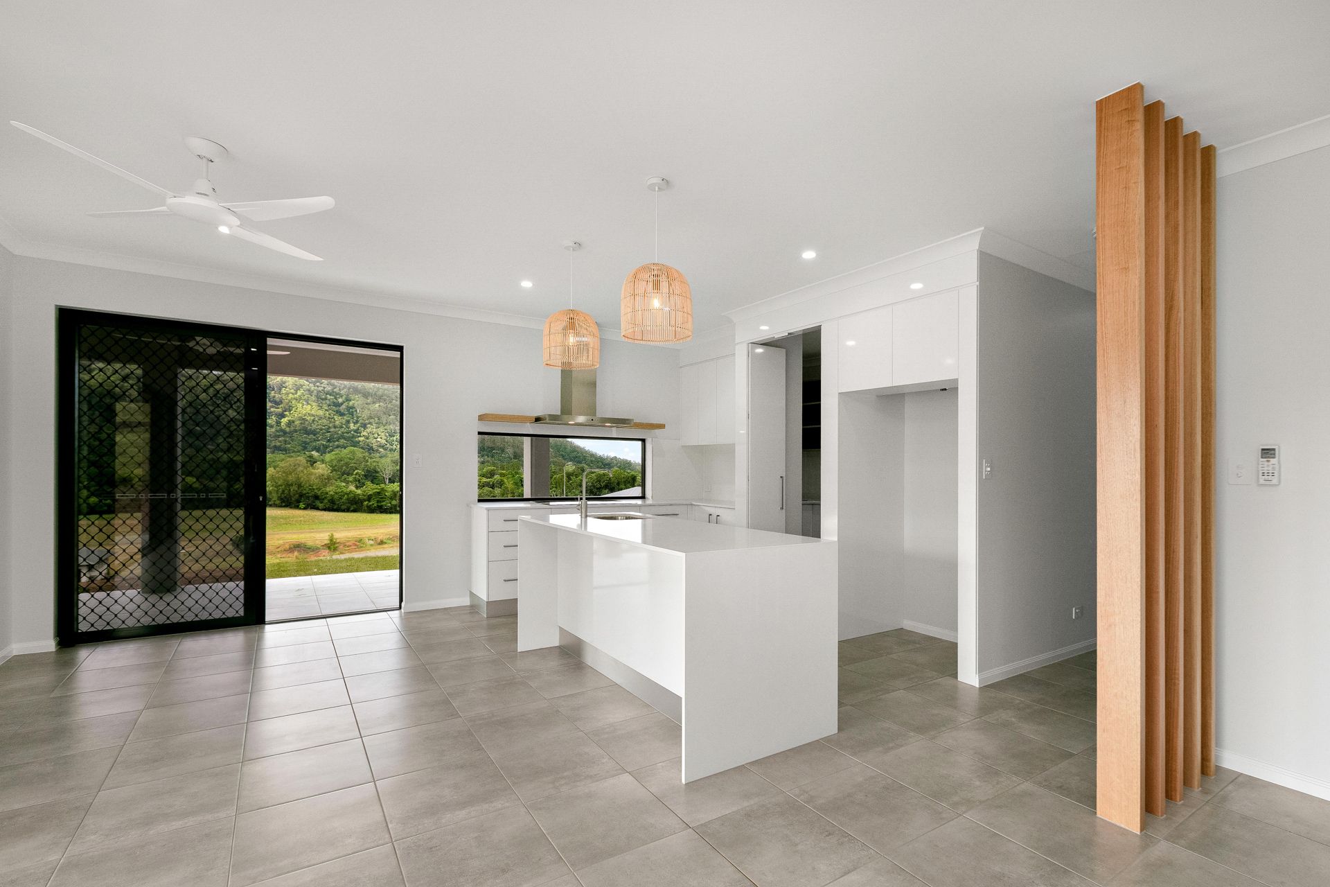A Modern, Open-plan Kitchen With White Cabinetry — Ashlee Jones Homes in Gordonvale, QLD