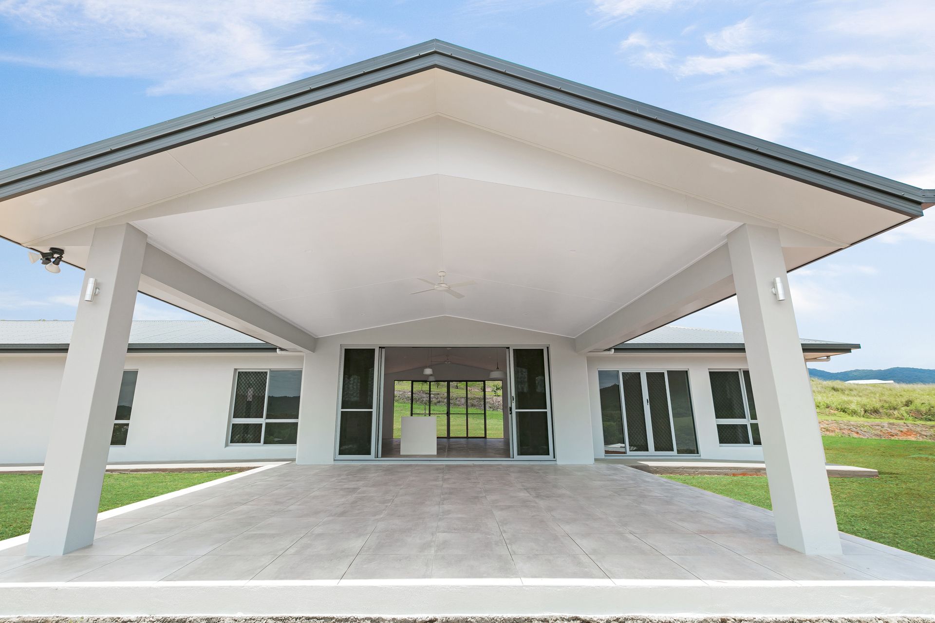 A Modern White House With a Large, Covered Concrete — Ashlee Jones Homes in Gordonvale, QLD