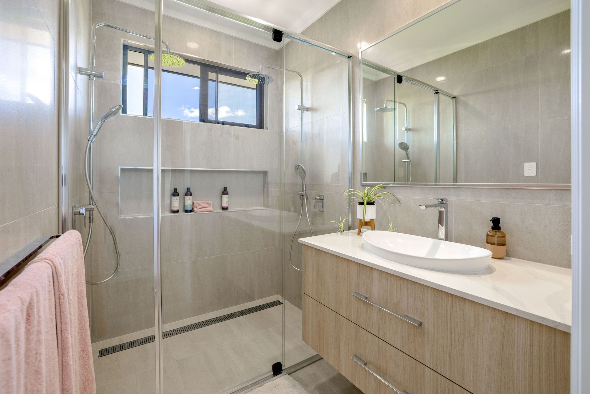 Modern Bathroom Featuring a Glass-enclosed Walk-in Shower — Ashlee Jones Homes in Gordonvale, QLD