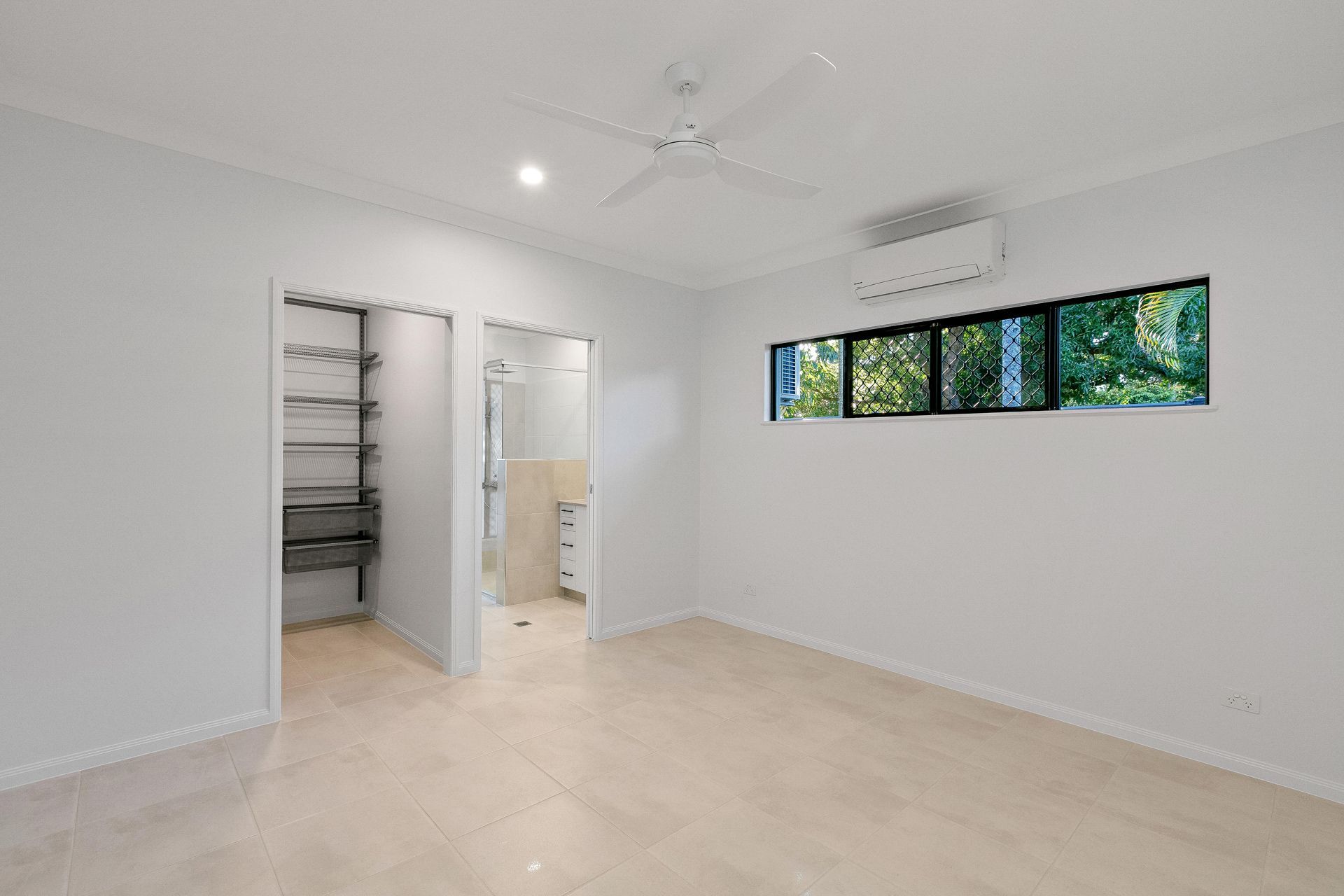 A Bright, Minimalist Bedroom With White Walls — Ashlee Jones Homes in Gordonvale, QLD