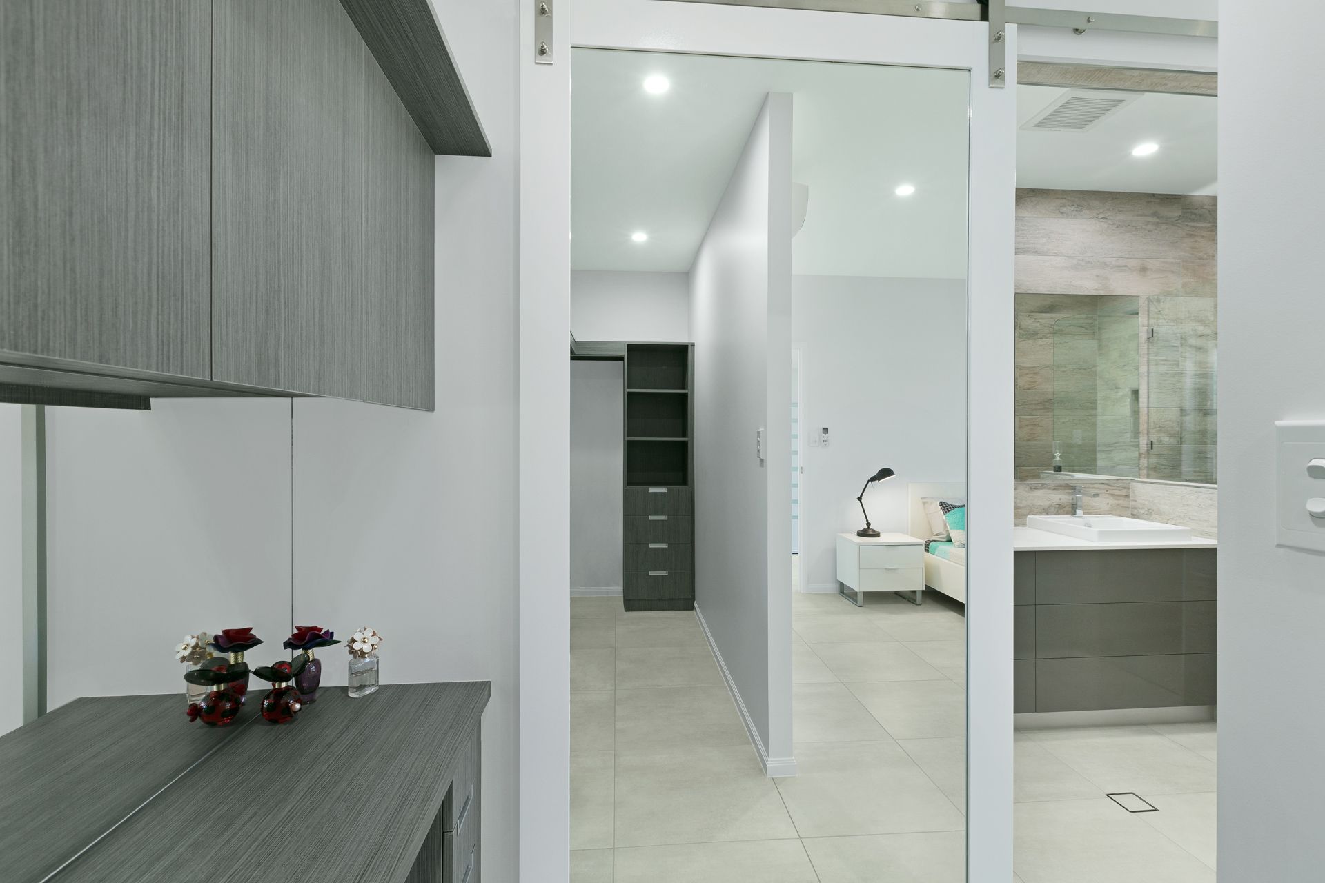 A View Through a White Sliding Door Into a Walk-in Closet — Ashlee Jones Homes in Gordonvale, QLD