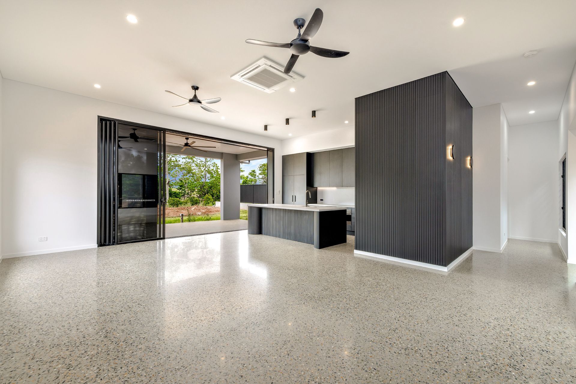A Modern Open-plan Living Area With Terrazzo Floors — Ashlee Jones Homes in Gordonvale, QLD
