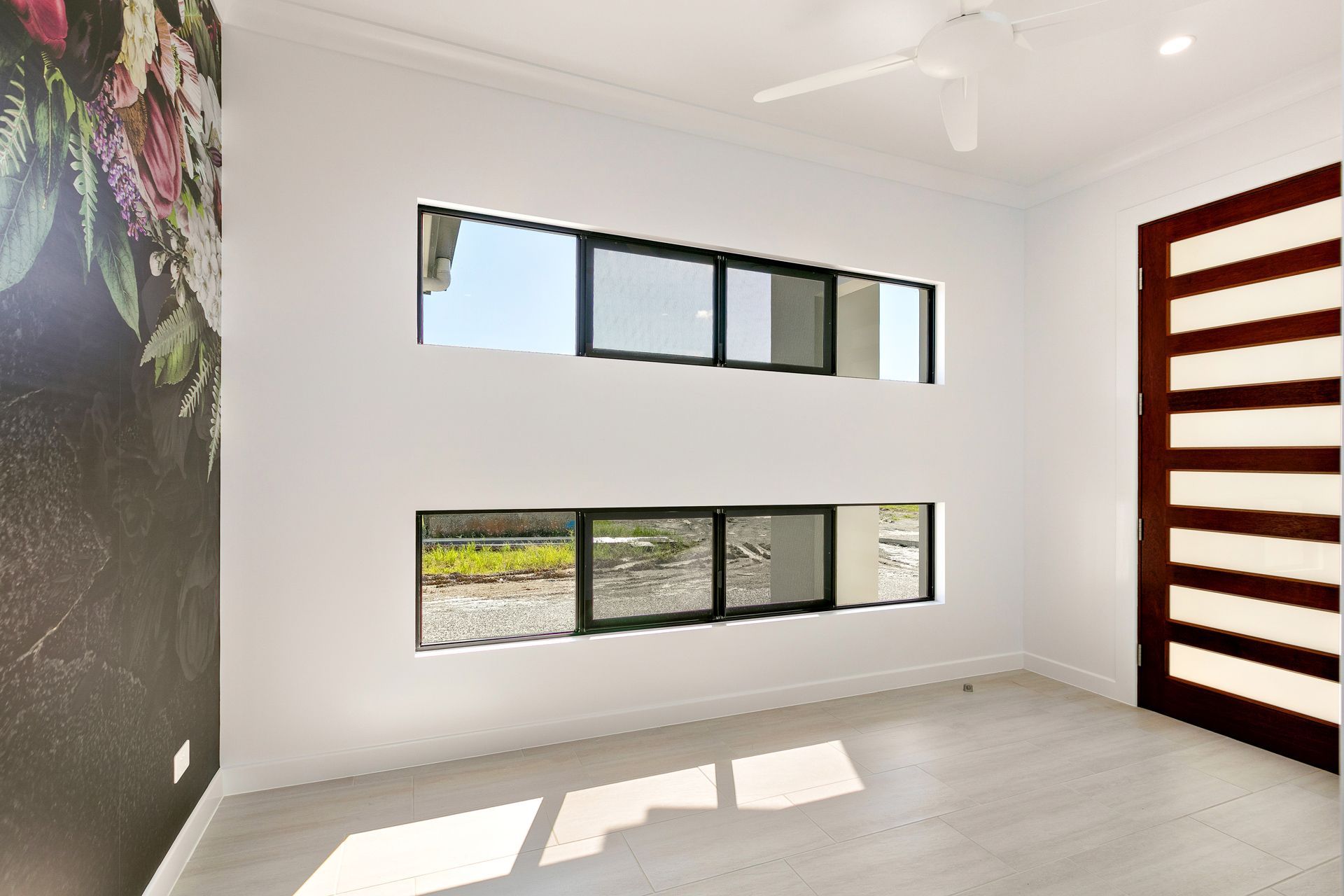 A Bright, Modern Room Features White Walls, Horizontal Windows — Ashlee Jones Homes in Gordonvale, QLD