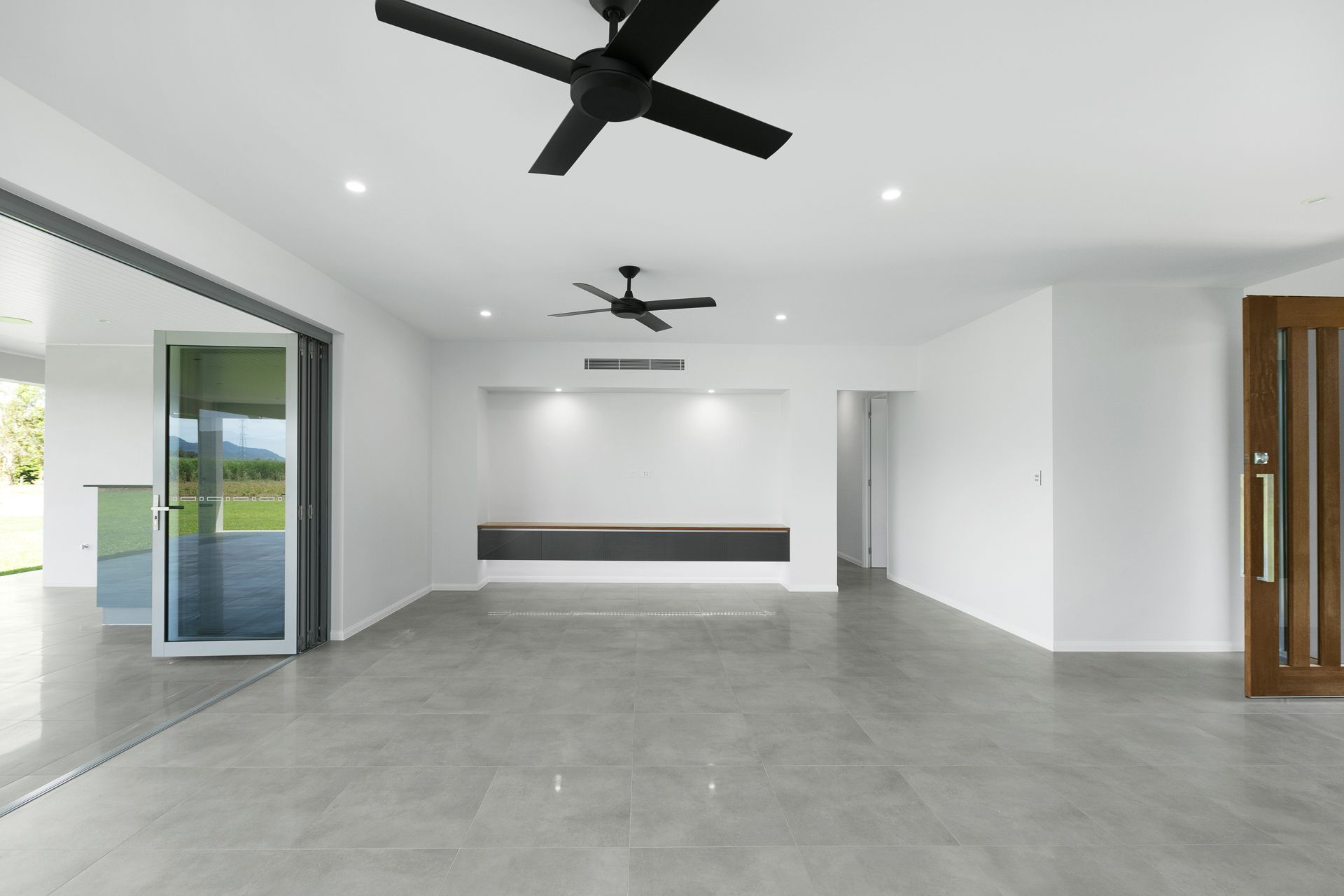 A Minimalist, Modern Living Space With Grey Tiled Floors — Ashlee Jones Homes in Gordonvale, QLD