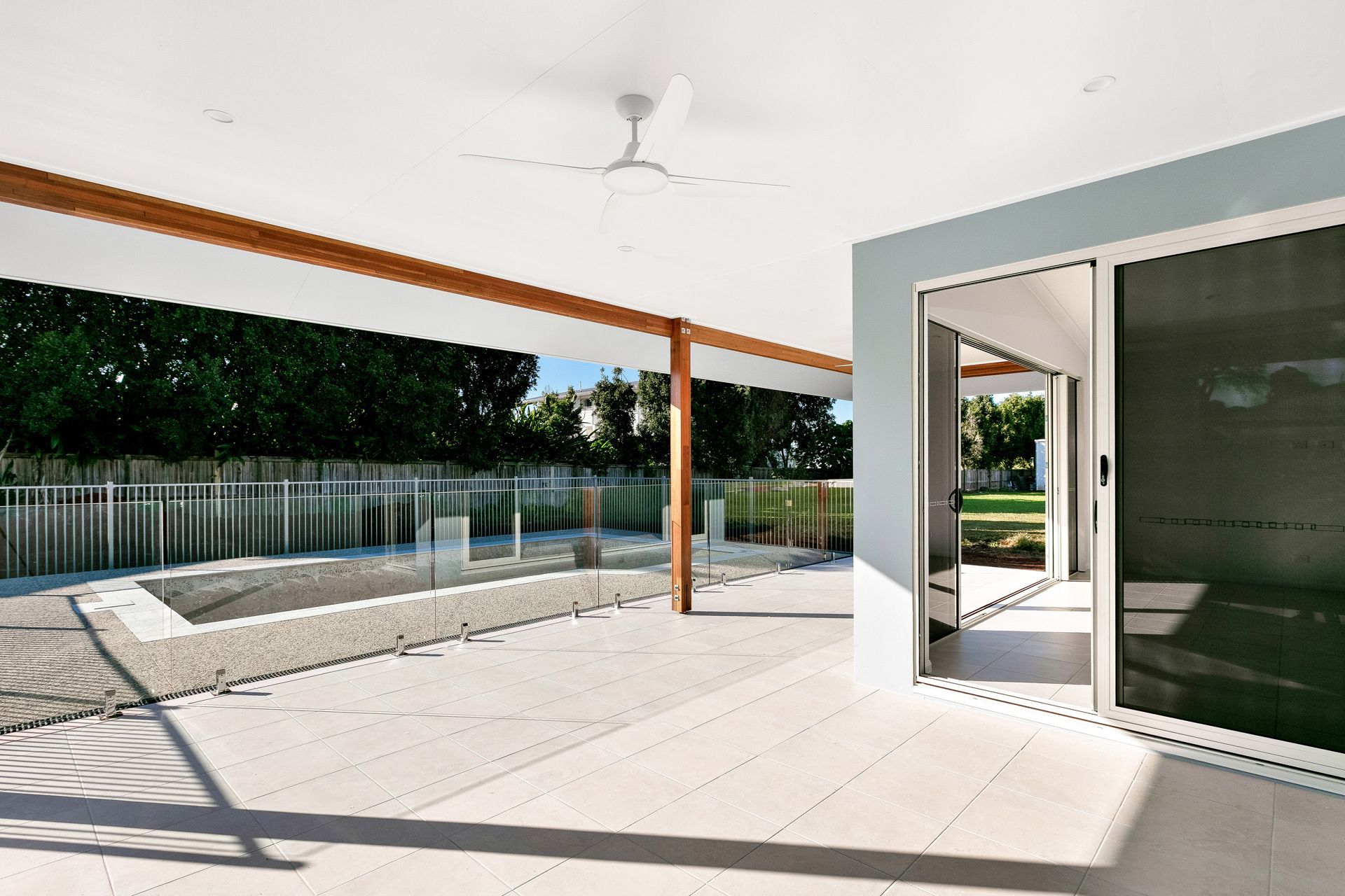A Covered Patio With a White Ceiling and Tiled Floor — Ashlee Jones Homes in Gordonvale, QLD