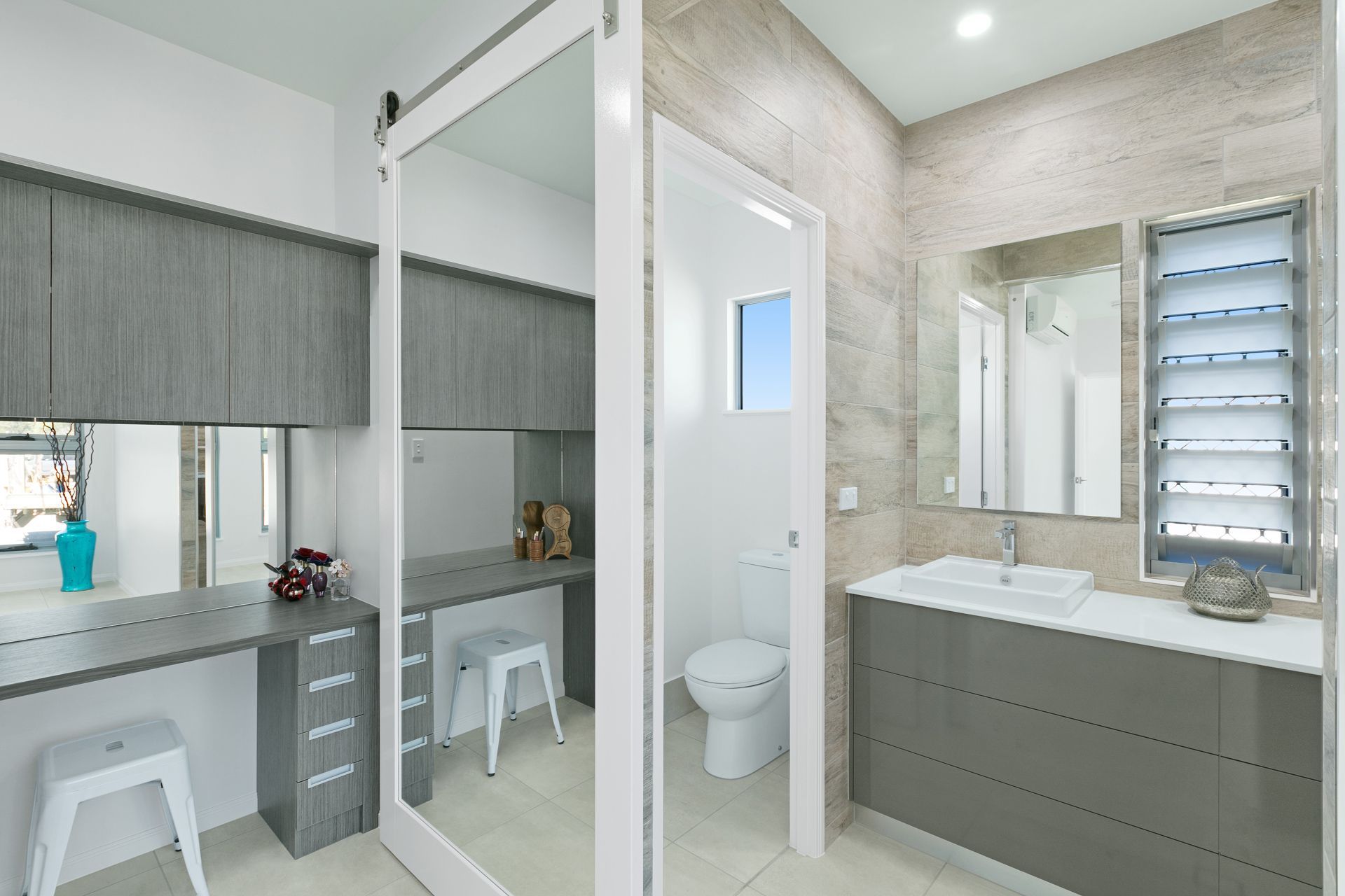 Modern Bathroom With a Gray Vanity, Floating Desk — Ashlee Jones Homes in Gordonvale, QLD