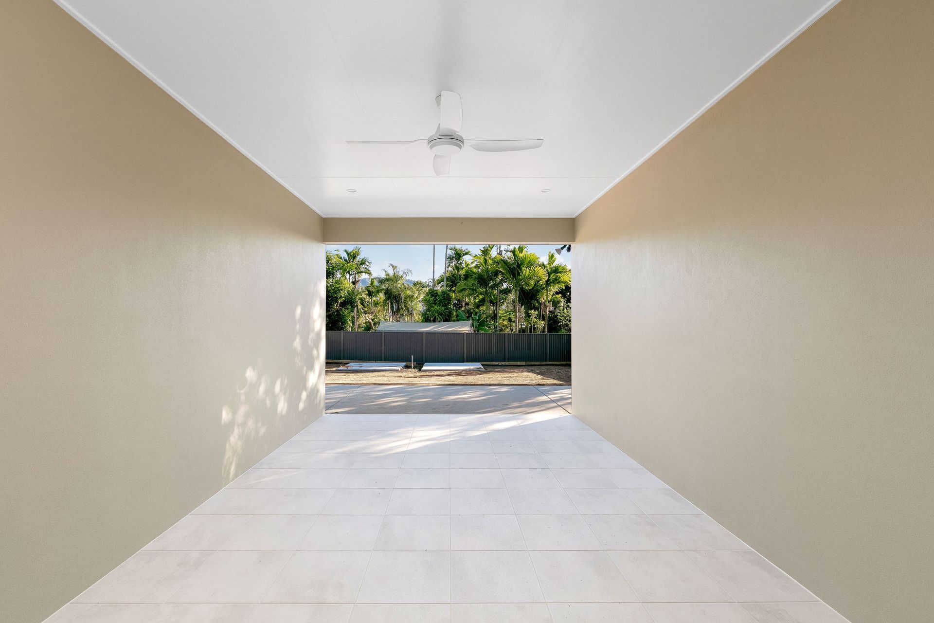A Covered Outdoor Patio With Light Beige Walls — Ashlee Jones Homes in Gordonvale, QLD