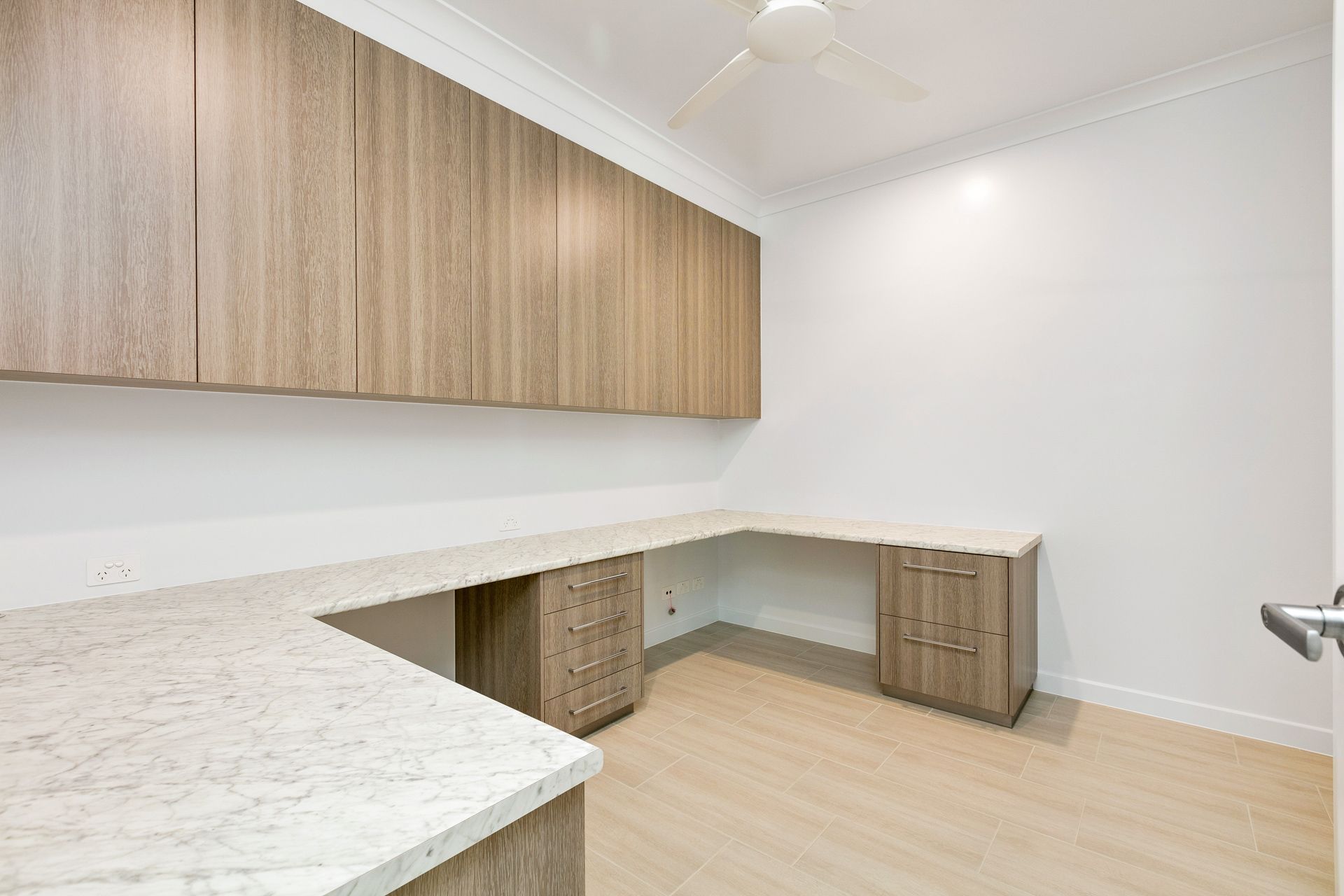A Home Office or Workspace With L-shaped Marble-topped Desks — Ashlee Jones Homes in Gordonvale, QLD