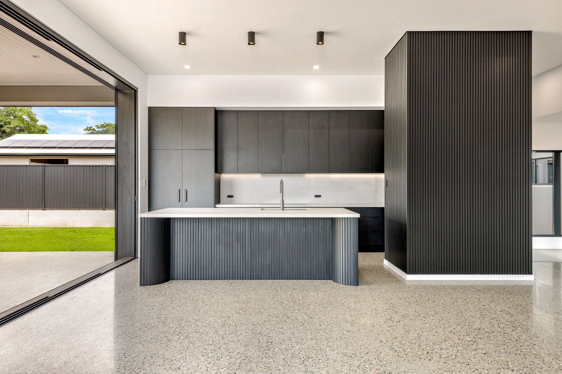 Modern Minimalist Kitchen With Dark Wood Cabinetry — Ashlee Jones Homes in Gordonvale, QLD