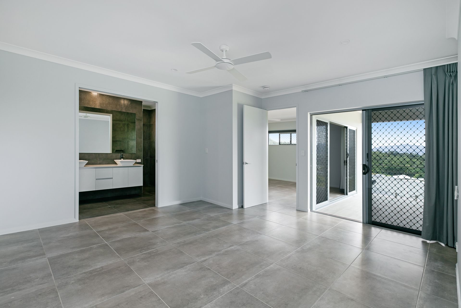 A Minimalist Bedroom With Light Grey Walls — Ashlee Jones Homes in Gordonvale, QLD
