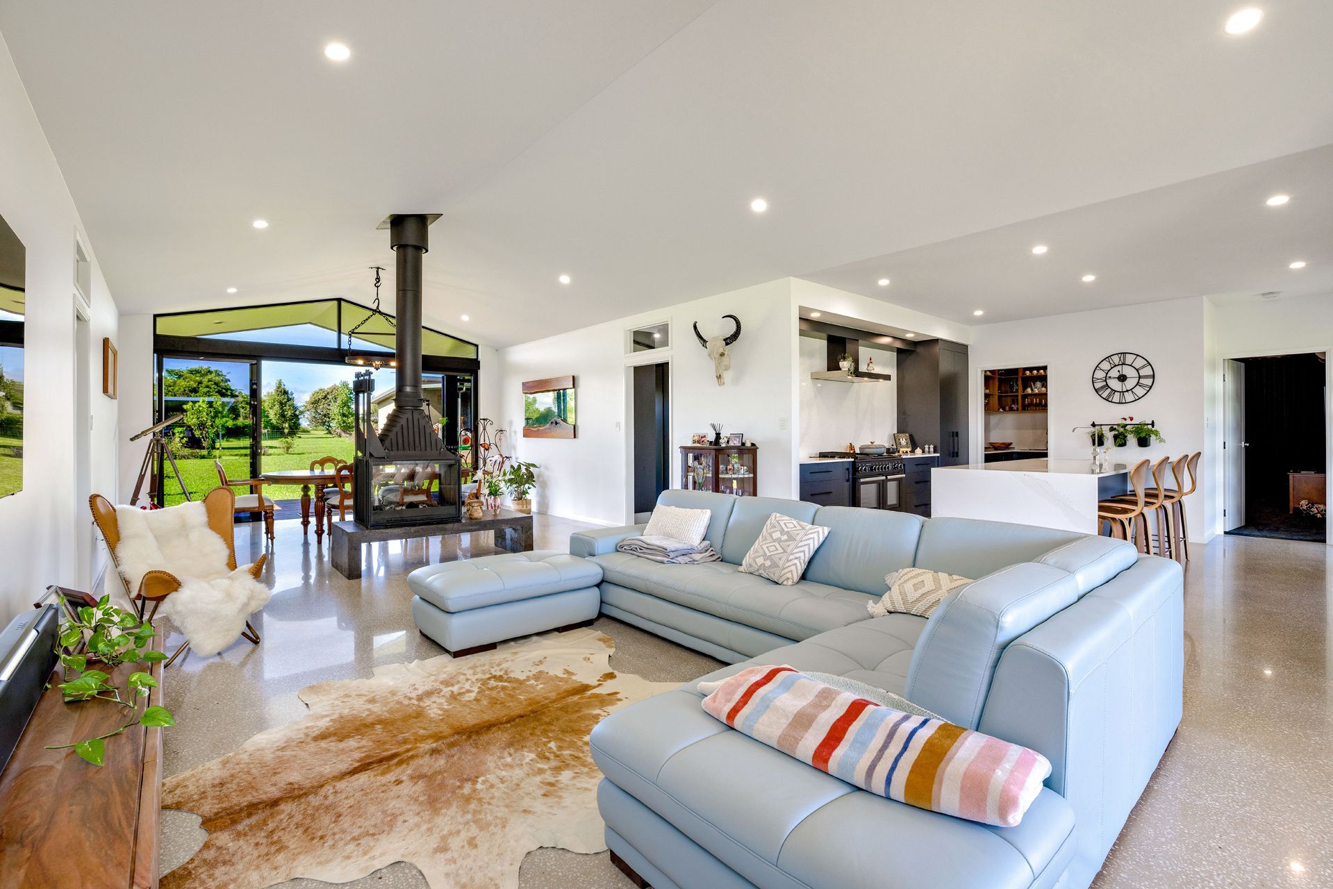 Spacious, Modern Living Room Featuring a Large Light Blue Sectional Sofa — Ashlee Jones Homes in Gordonvale, QLD