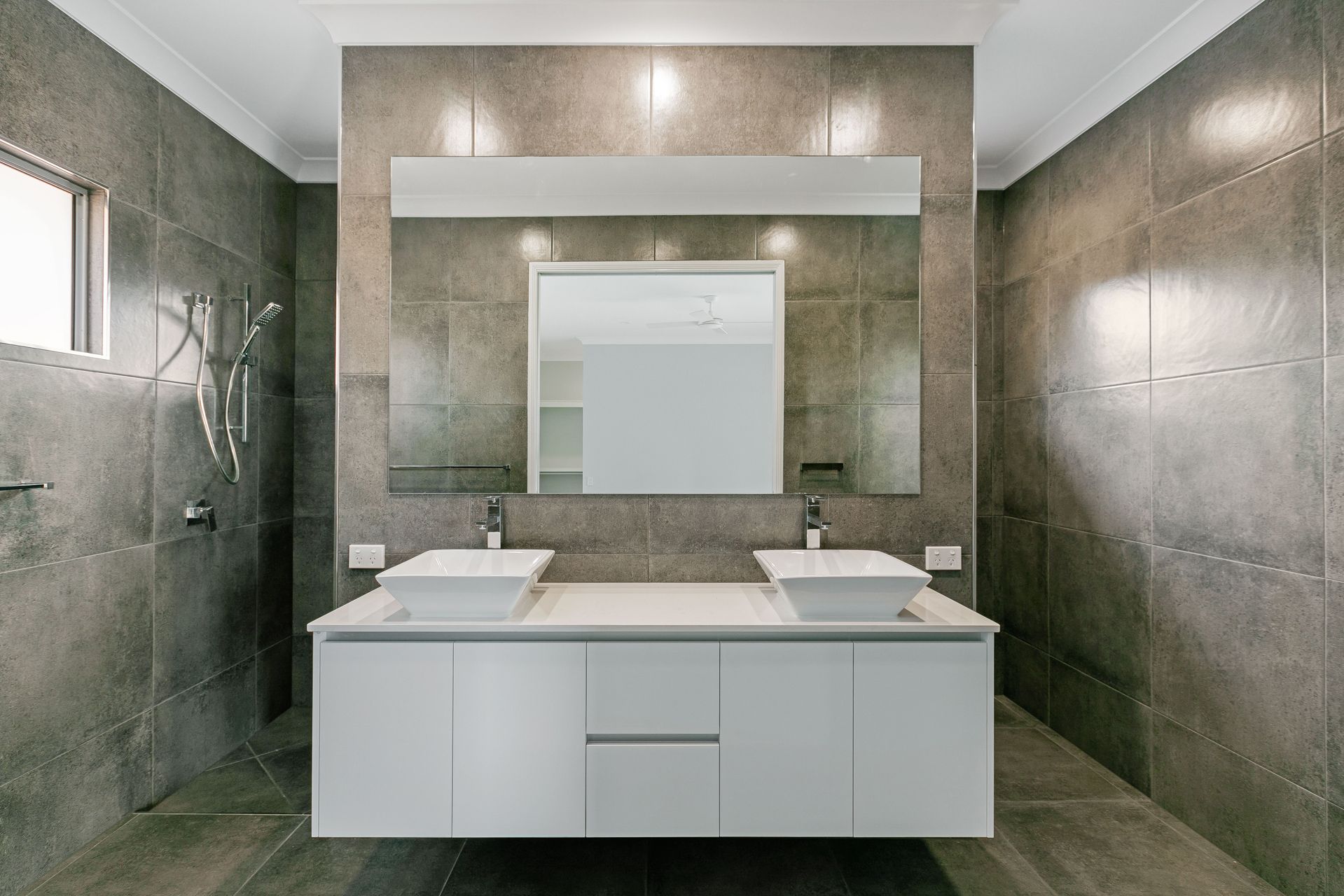 A Modern Bathroom With a White Double-sink Vanity — Ashlee Jones Homes in Gordonvale, QLD