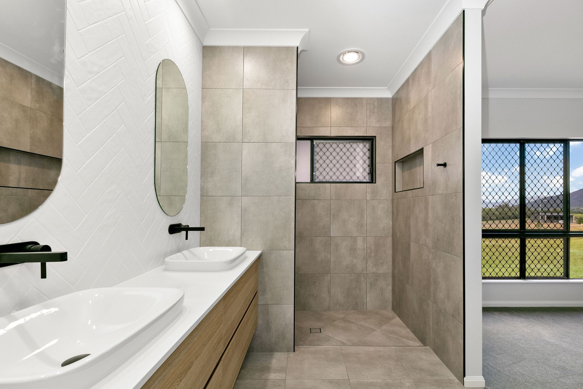 Modern Bathroom With a Double Vanity, Neutral Stone Tiles — Ashlee Jones Homes in Gordonvale, QLD