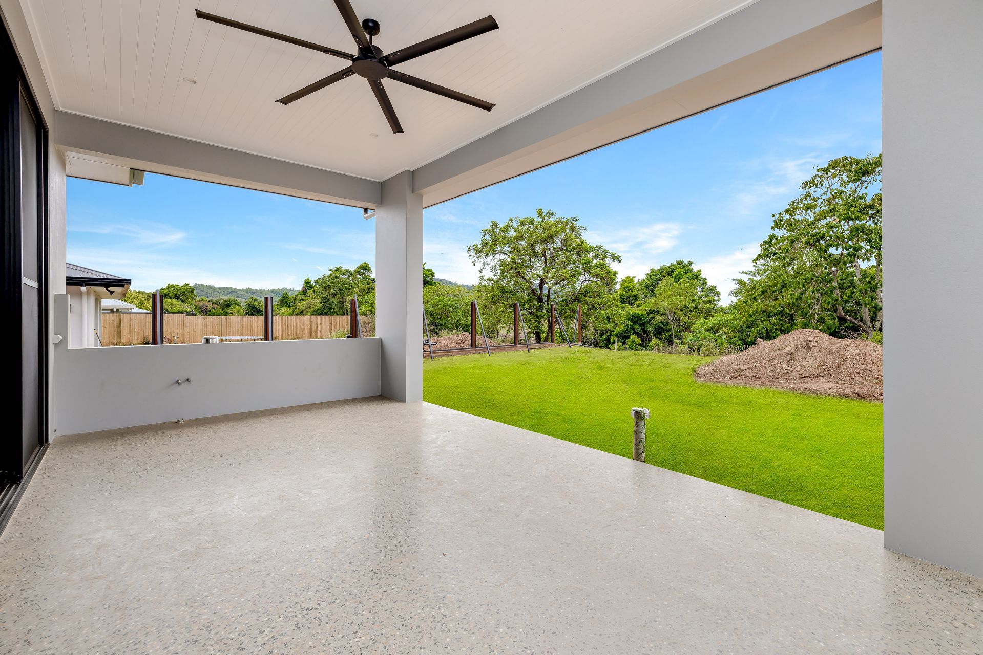 A Covered Patio With a Speckled Concrete Floor — Ashlee Jones Homes in Gordonvale, QLD