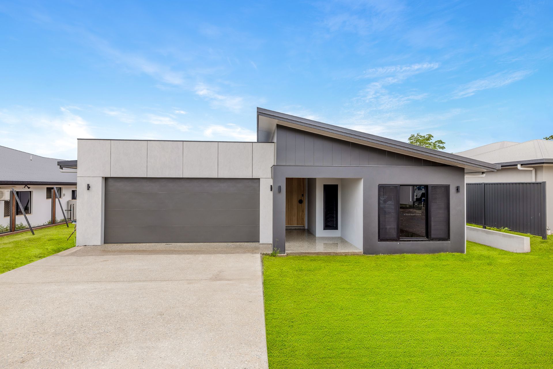 Modern Single-story House With a Grey Garage and Dark Exterior Accents — Ashlee Jones Homes in Gordonvale, QLD