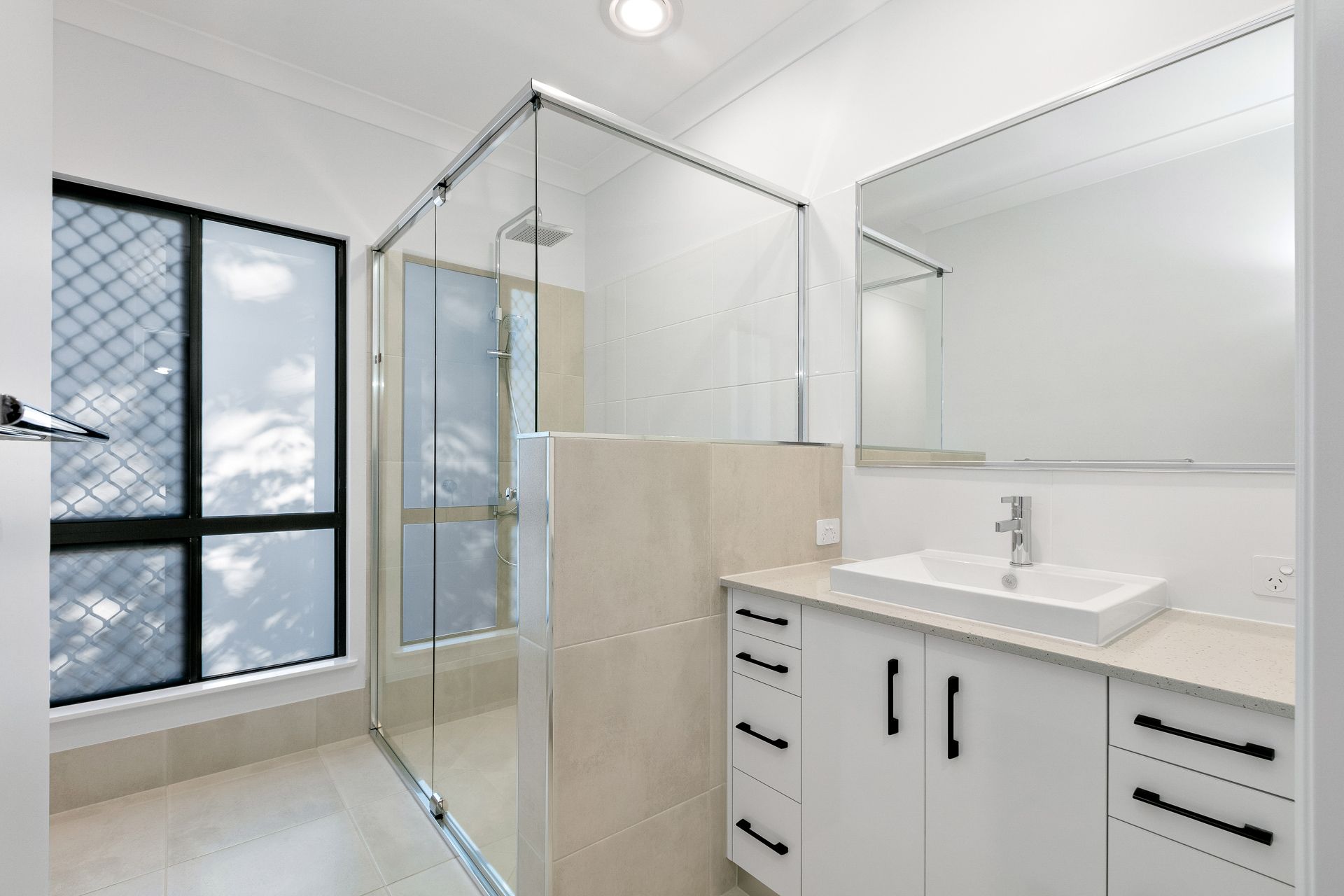 Modern White Bathroom Featuring a Walk-in Glass Shower — Ashlee Jones Homes in Gordonvale, QLD