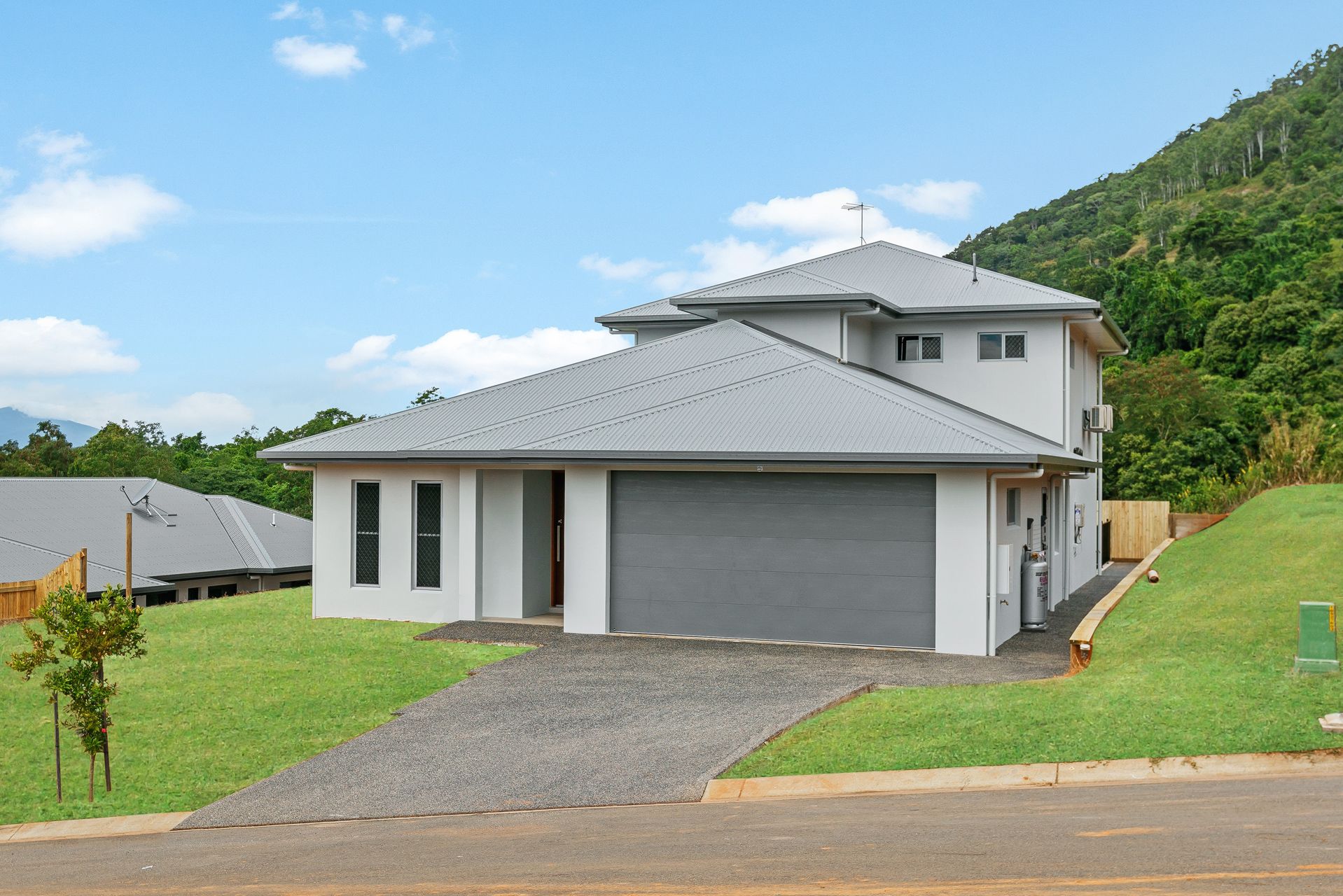 A Light-colored Two-story Suburban House With a Gray Roof — Ashlee Jones Homes in Gordonvale, QLD