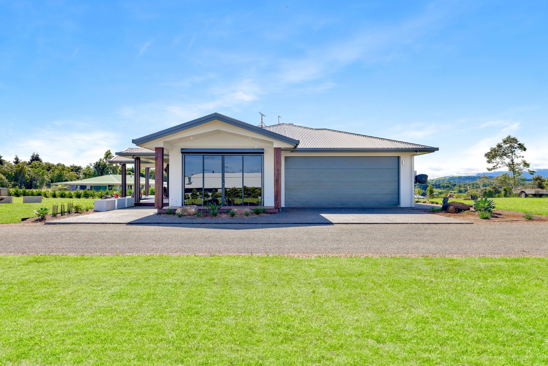 A Modern, One-story House With a Grey Tile Roof and Large Windows — Ashlee Jones Homes in Gordonvale, QLD