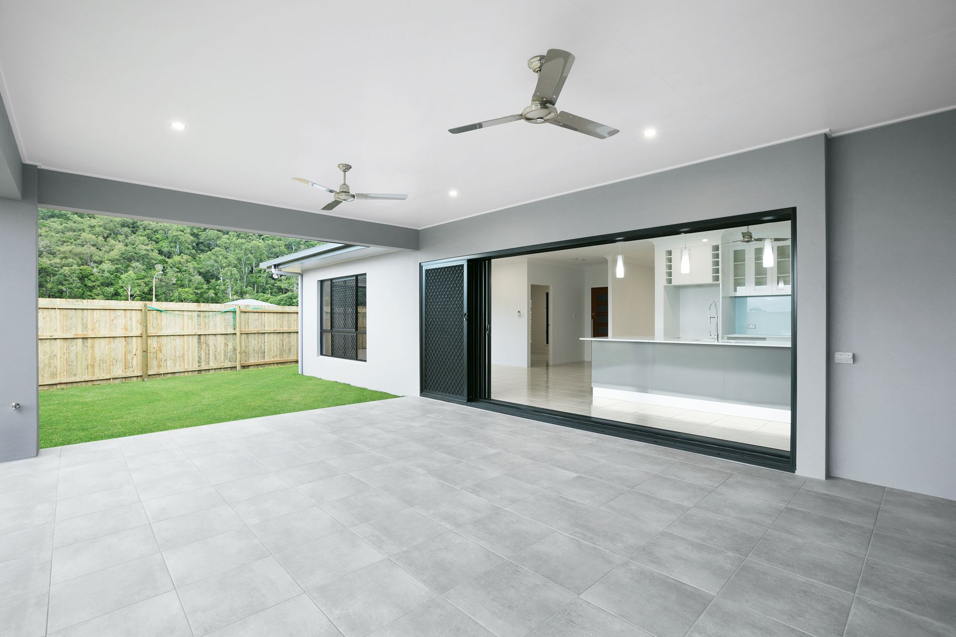 Modern Covered Patio With Gray Tile Flooring — Ashlee Jones Homes in Gordonvale, QLD