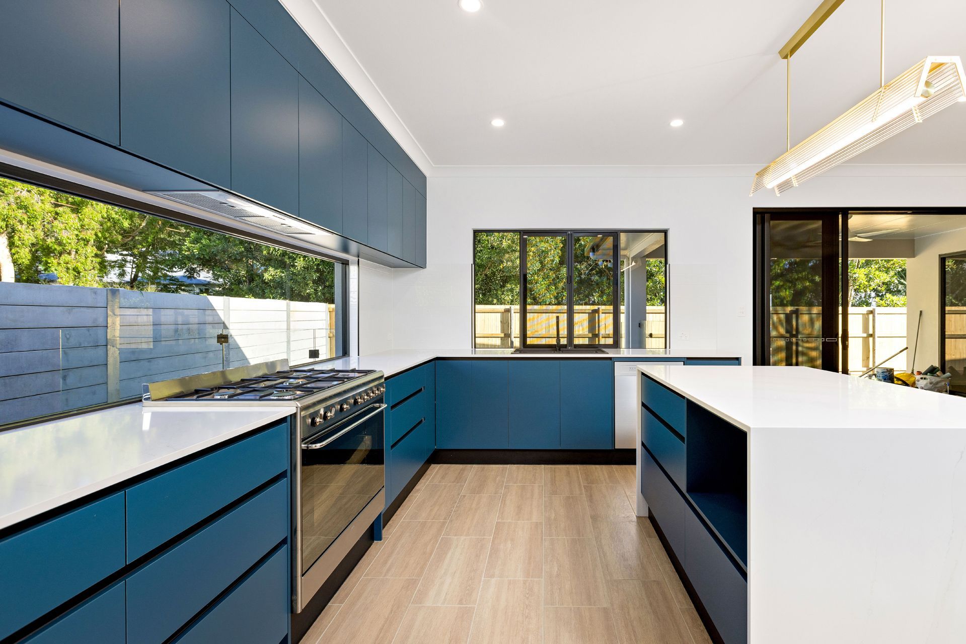 A Modern Kitchen Featuring Matte Blue Cabinetry — Ashlee Jones Homes in Gordonvale, QLD