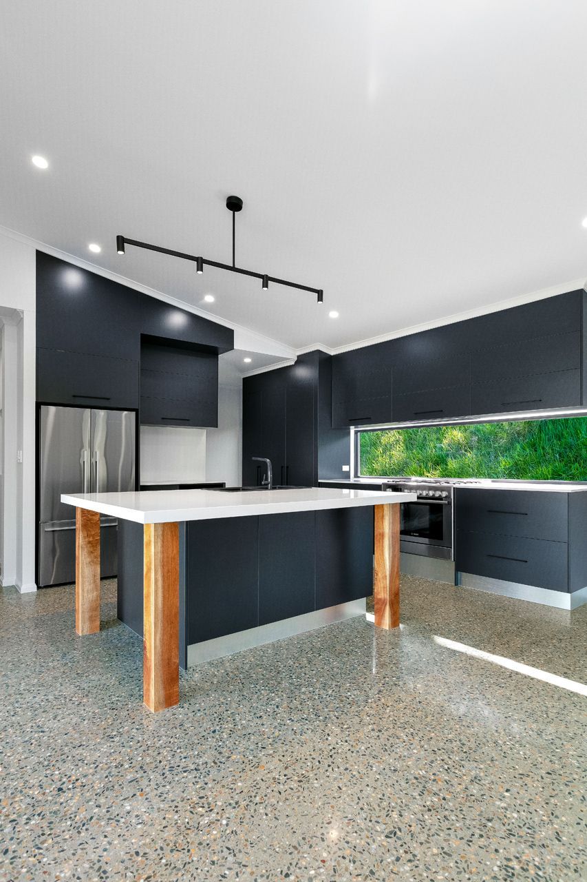 Modern Kitchen With Matte Dark Cabinetry — Ashlee Jones Homes in Gordonvale, QLD