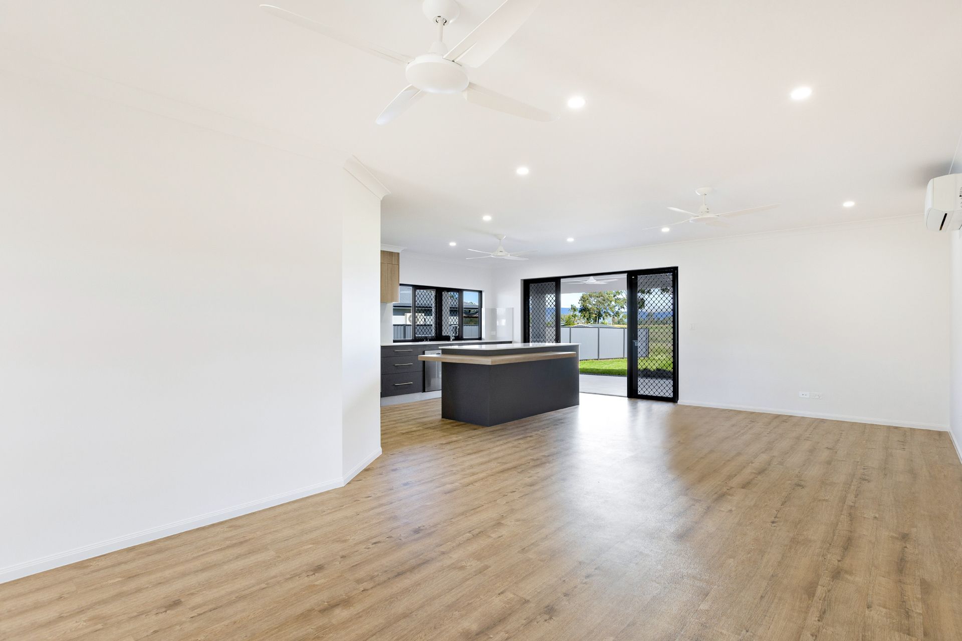 A Spacious, Modern Open-plan Room With White Walls — Ashlee Jones Homes in Gordonvale, QLD