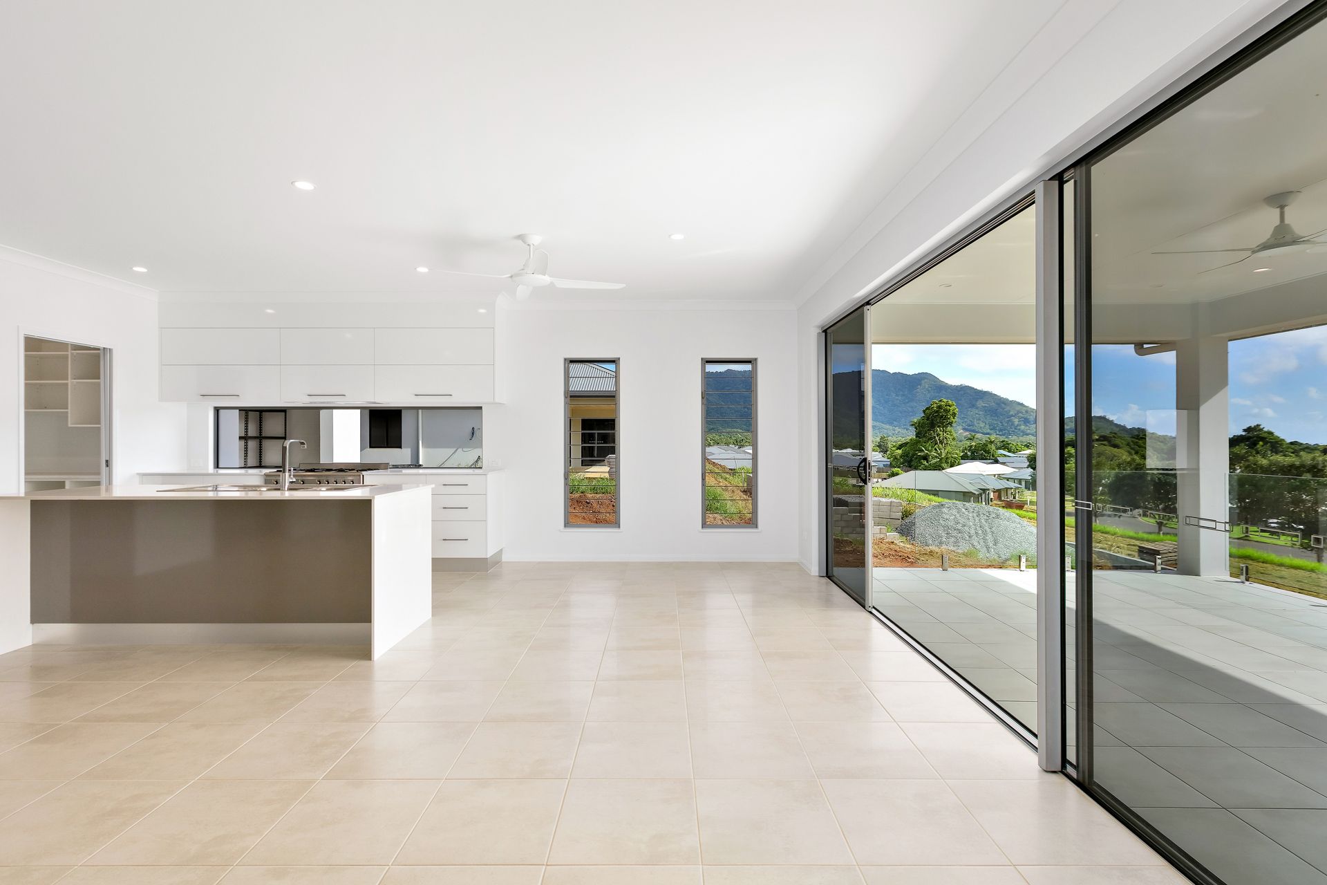 Modern, White-walled Open Kitchen and Living Area — Ashlee Jones Homes in Gordonvale, QLD