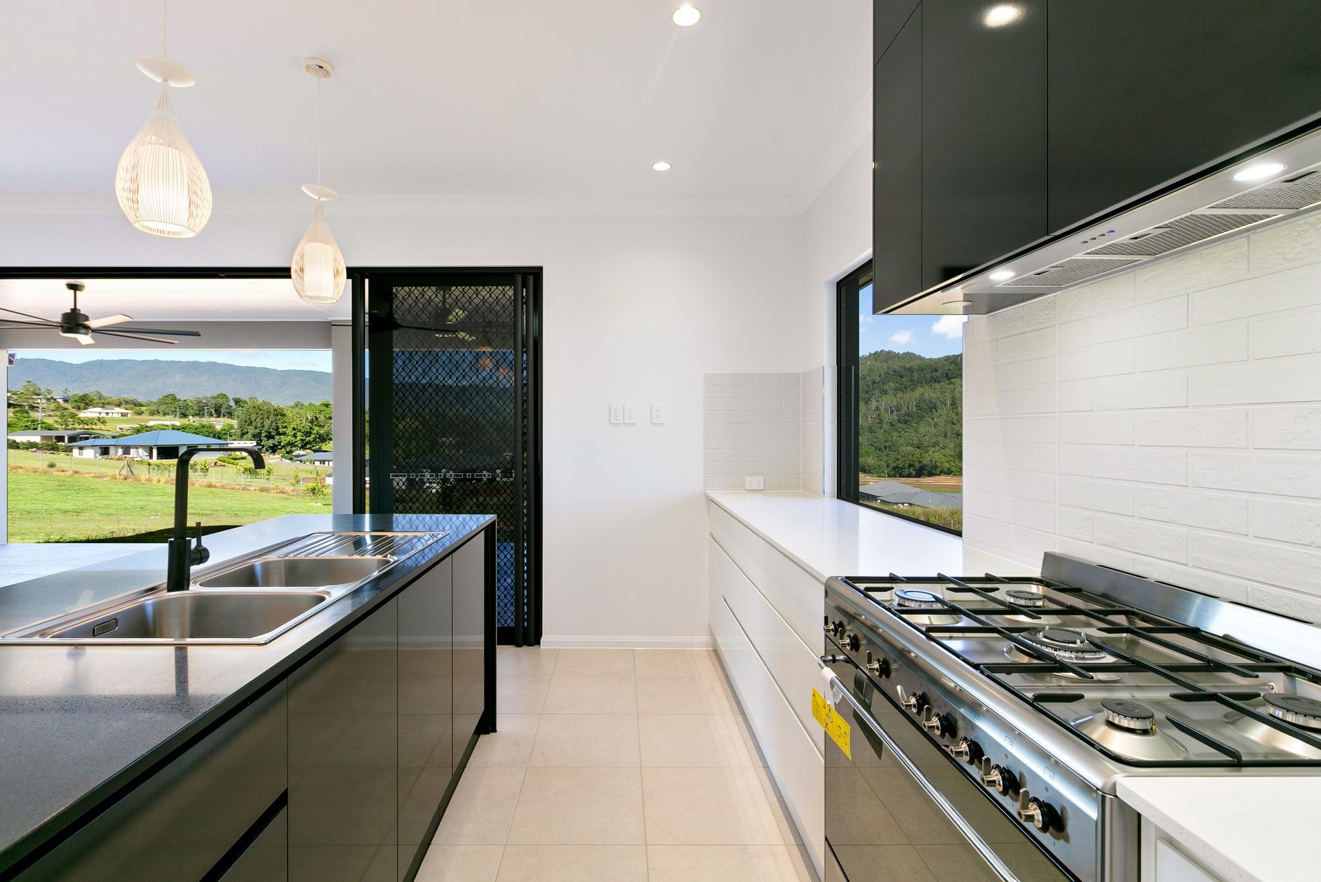 Modern Kitchen With a Dark Island Countertop — Ashlee Jones Homes in Gordonvale, QLD