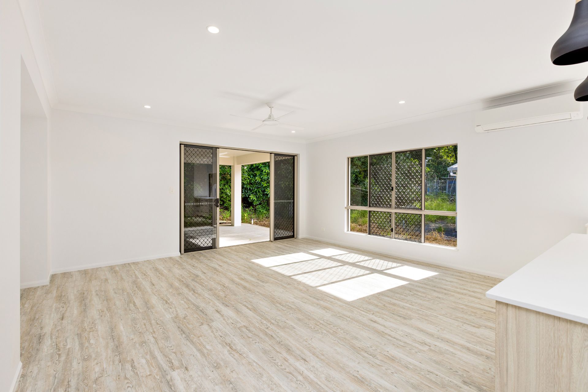 An Open-plan Living Room With White Walls — Ashlee Jones Homes in Gordonvale, QLD
