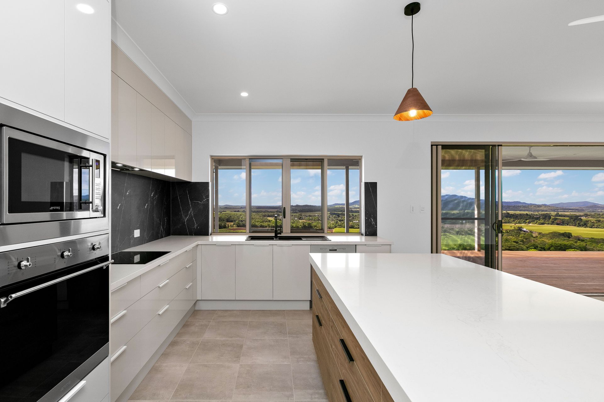 A Bright Modern Kitchen With White Cabinetry — Ashlee Jones Homes in Gordonvale, QLD