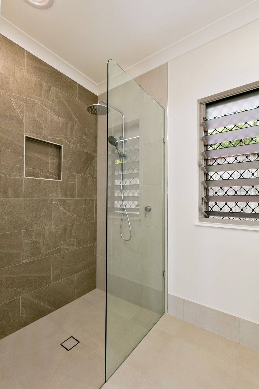 A Walk-in Shower With Brown Stone-look Walls — Ashlee Jones Homes in Gordonvale, QLD