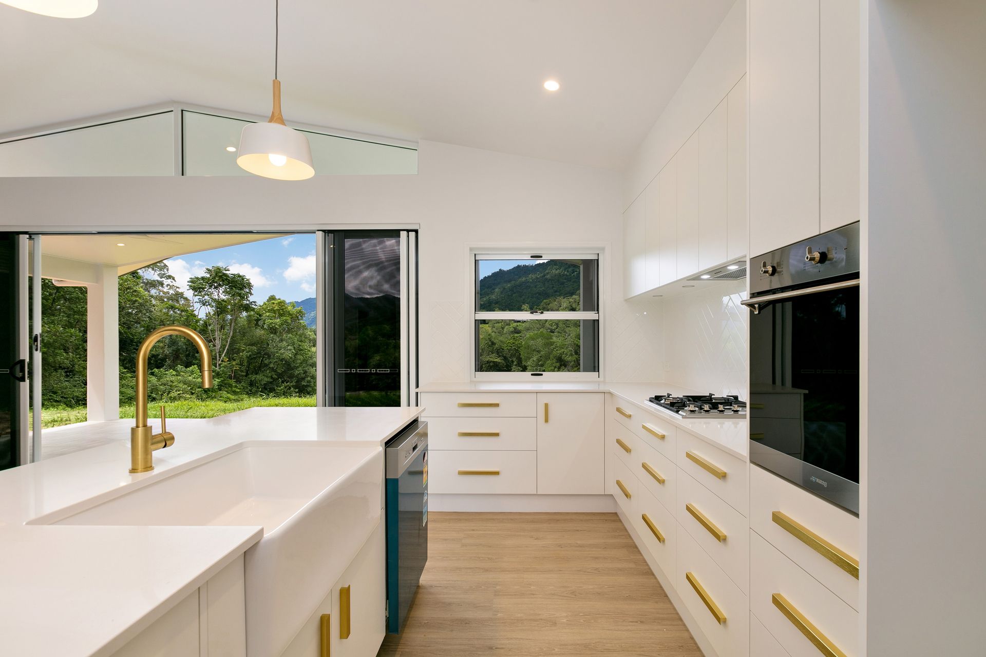 Modern White Kitchen Featuring Gold Hardware — Ashlee Jones Homes in Gordonvale, QLD