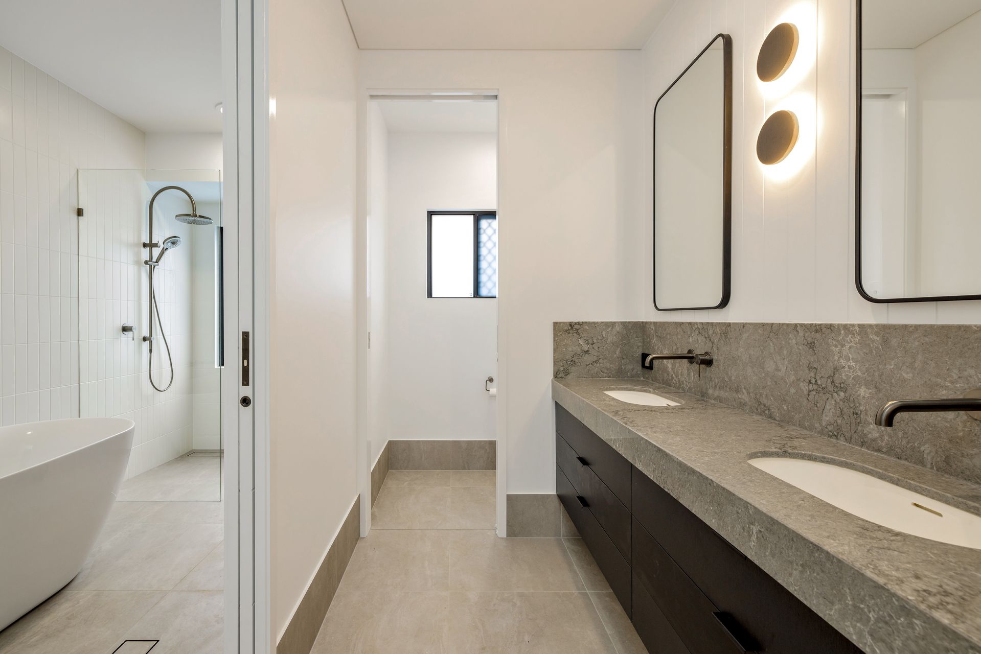 A Modern Bathroom With a Double Vanity, Stone Countertop — Ashlee Jones Homes in Gordonvale, QLD